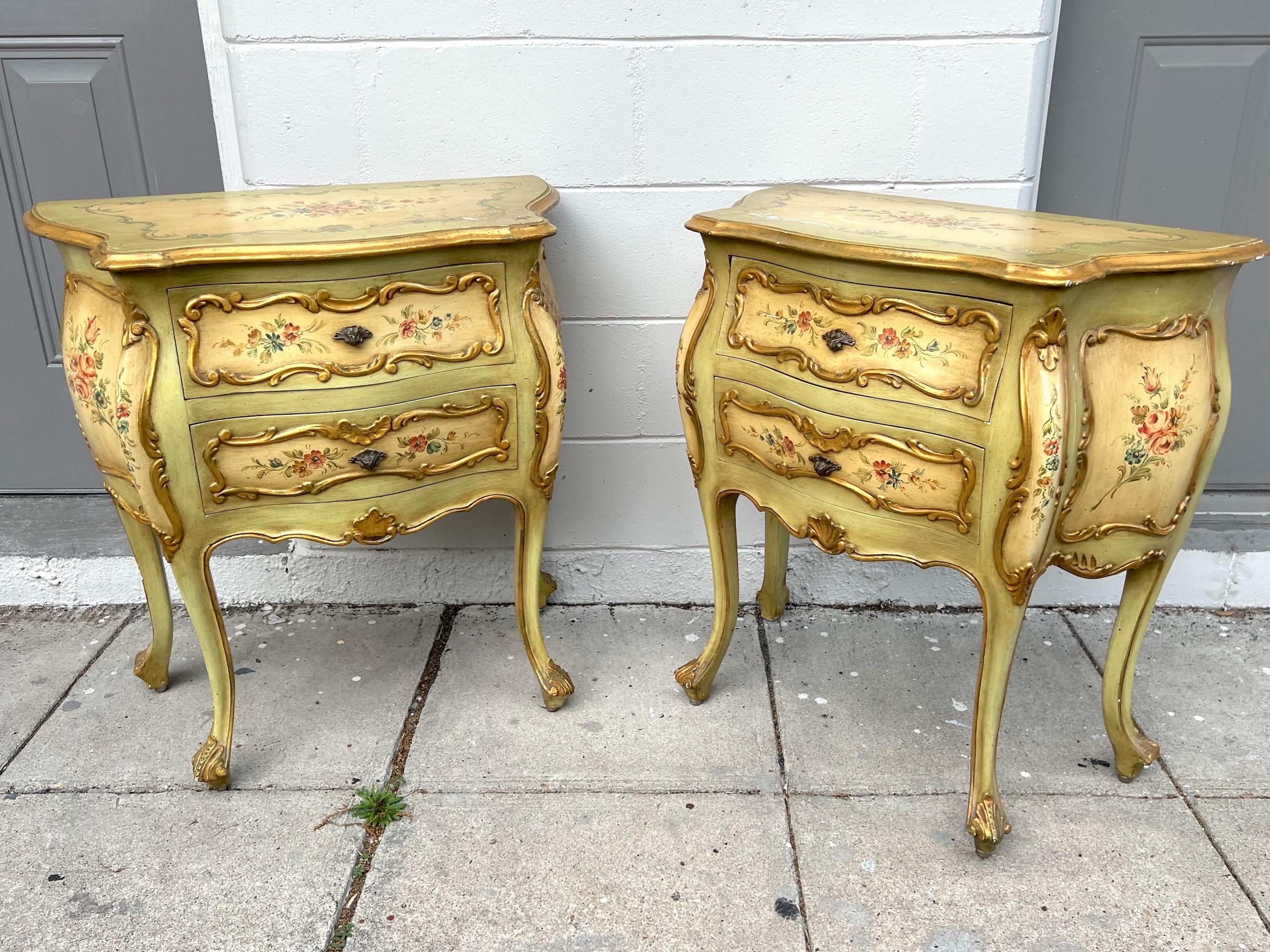 Vintage Florentine nightstand pair. Made in Italy.
Paint decorated floral design with gold gilded trim on serpentine style front. 
Cabriole legs with hand carved accents. 