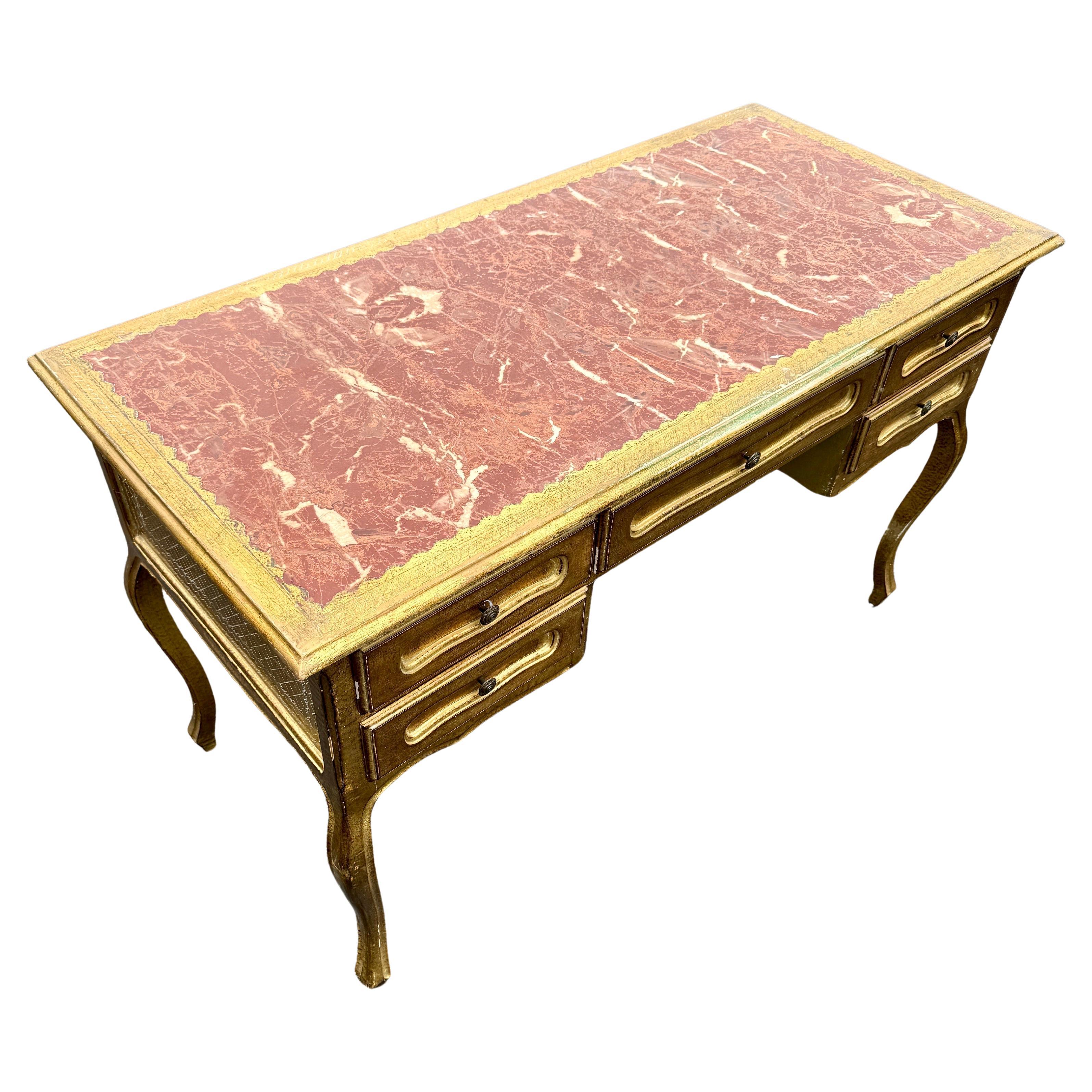 Florentine Writing Desk with 5 Drawers in Giltwood, Italy 1960's

This vintage wooden desk is remarkable with all its detailing including the writing surface featuring a leather faux marble top and cabriole legs. There is quite a bit of storage with