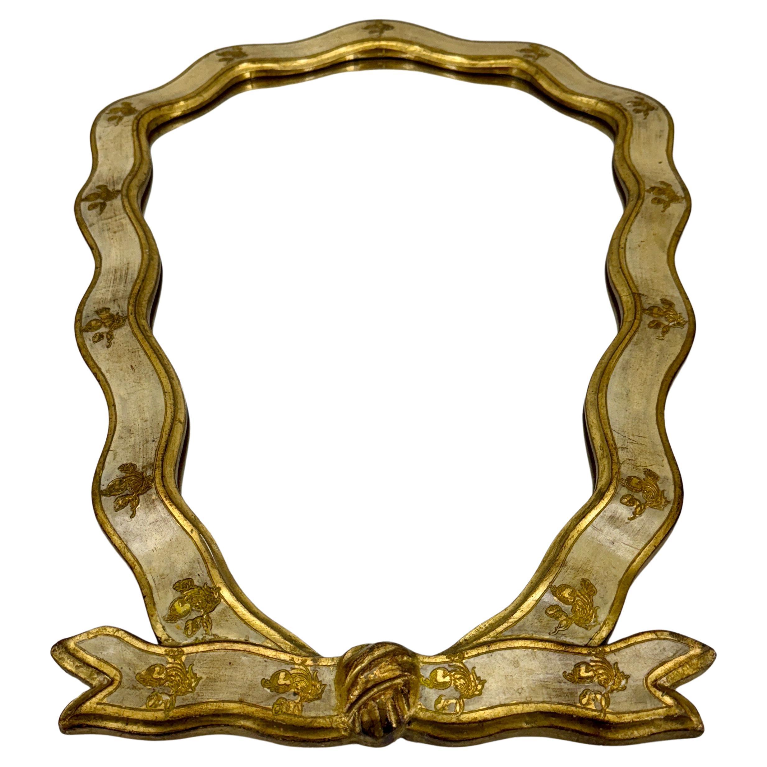 Florentine Gilt and Painted Ribbon Wall Mirror, 1950s, Italy

Charming classic style Italian gilded Florentine gold and cream wood mirror. Perfect piece to be used formally or informally in a hallway, bathroom, powder room, living room or bedroom.