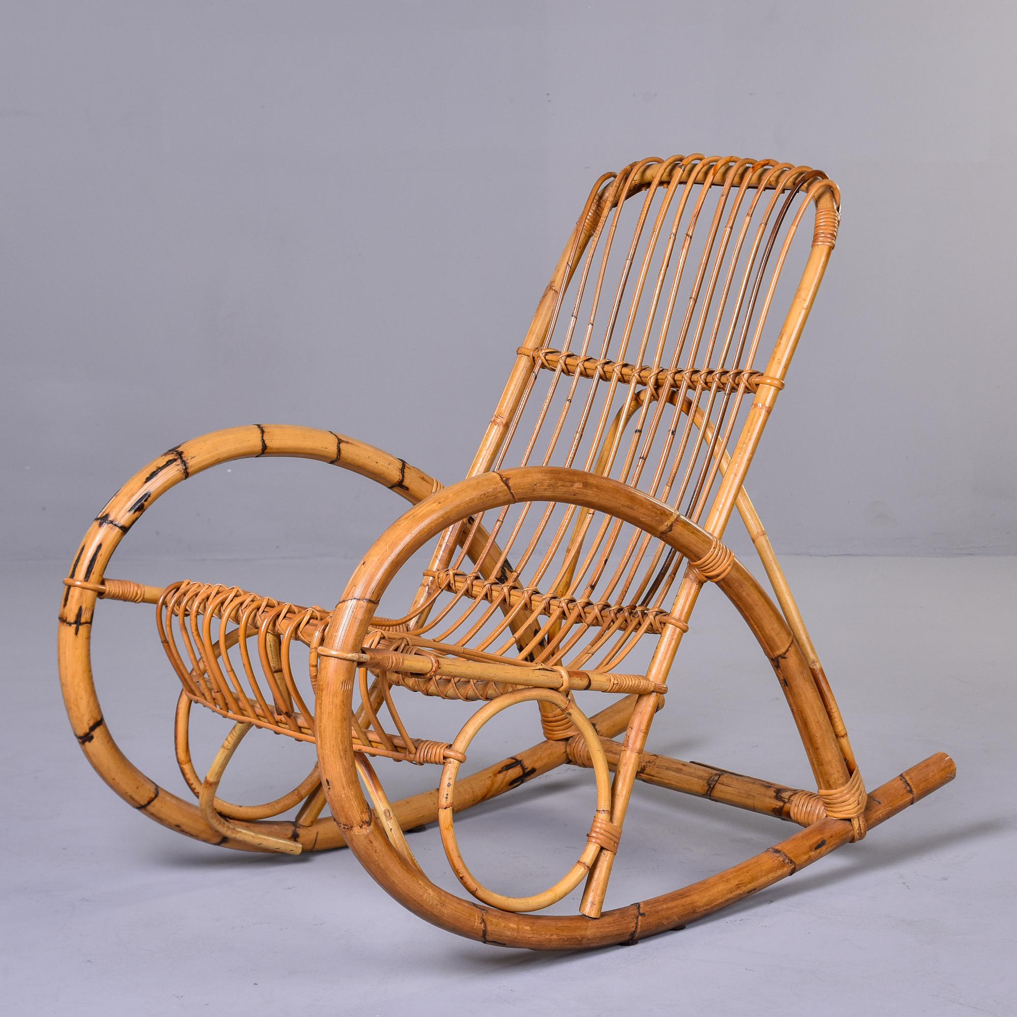 Circa 1960s rocking chair in bent bamboo by Italian designer Franco Albini. Compelling curvy lines with oversized, arms and rocker. Sits comfortably and well. We have the original cushion tufted corduroy cushion. 

Arm Height:  23.75”     Seat