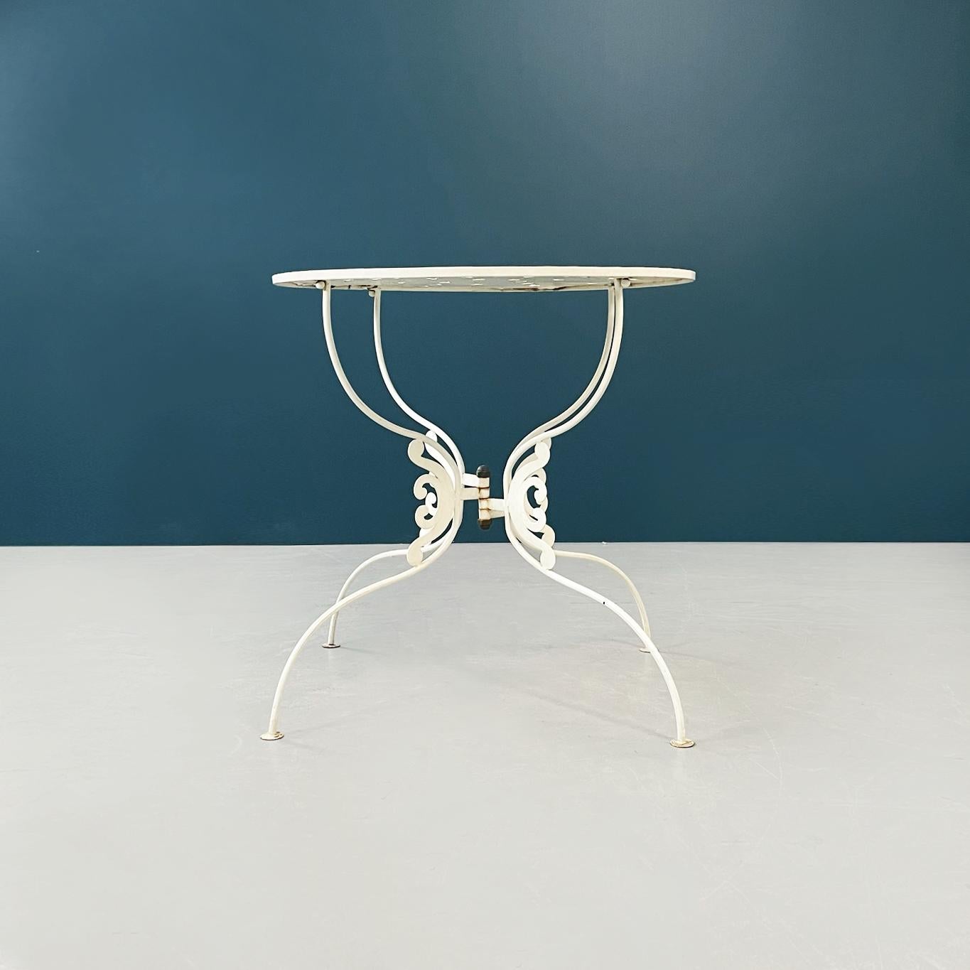Italian mid-century Garden table in white wrought iron finely worked, 1960s
Garden round table has a cream white painted wrought iron structure. The round top is perforated. The curved legs are finely worked in the center.
1960s.
Good conditions,