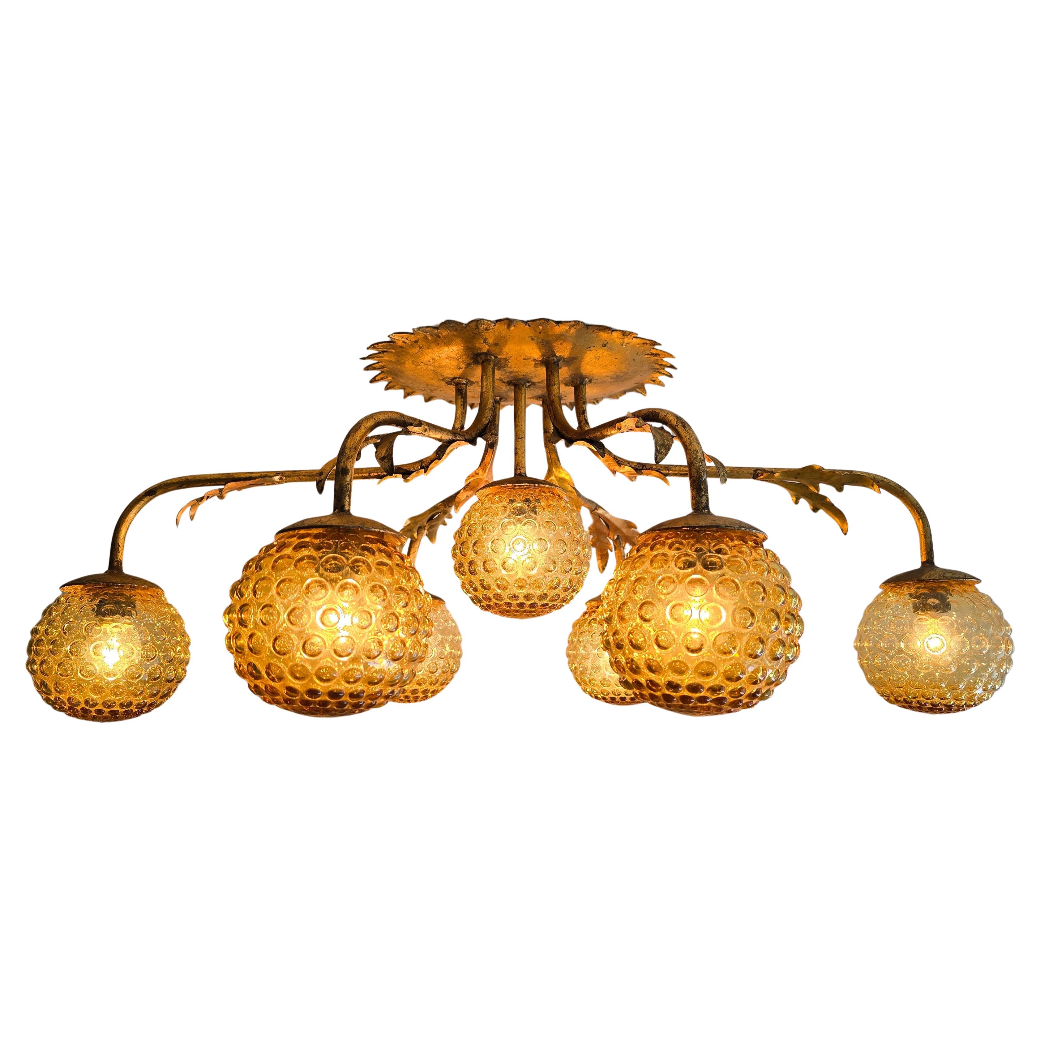 Italian Mid-Century Gilded Ceiling Lamp with Amber Bubble Glass, 1970s

A rare and decorative Italian ceiling lamp from the 1950s featuring seven sculptural arms in gilded metal with leaf details and large amber bubble glass globes. The organic