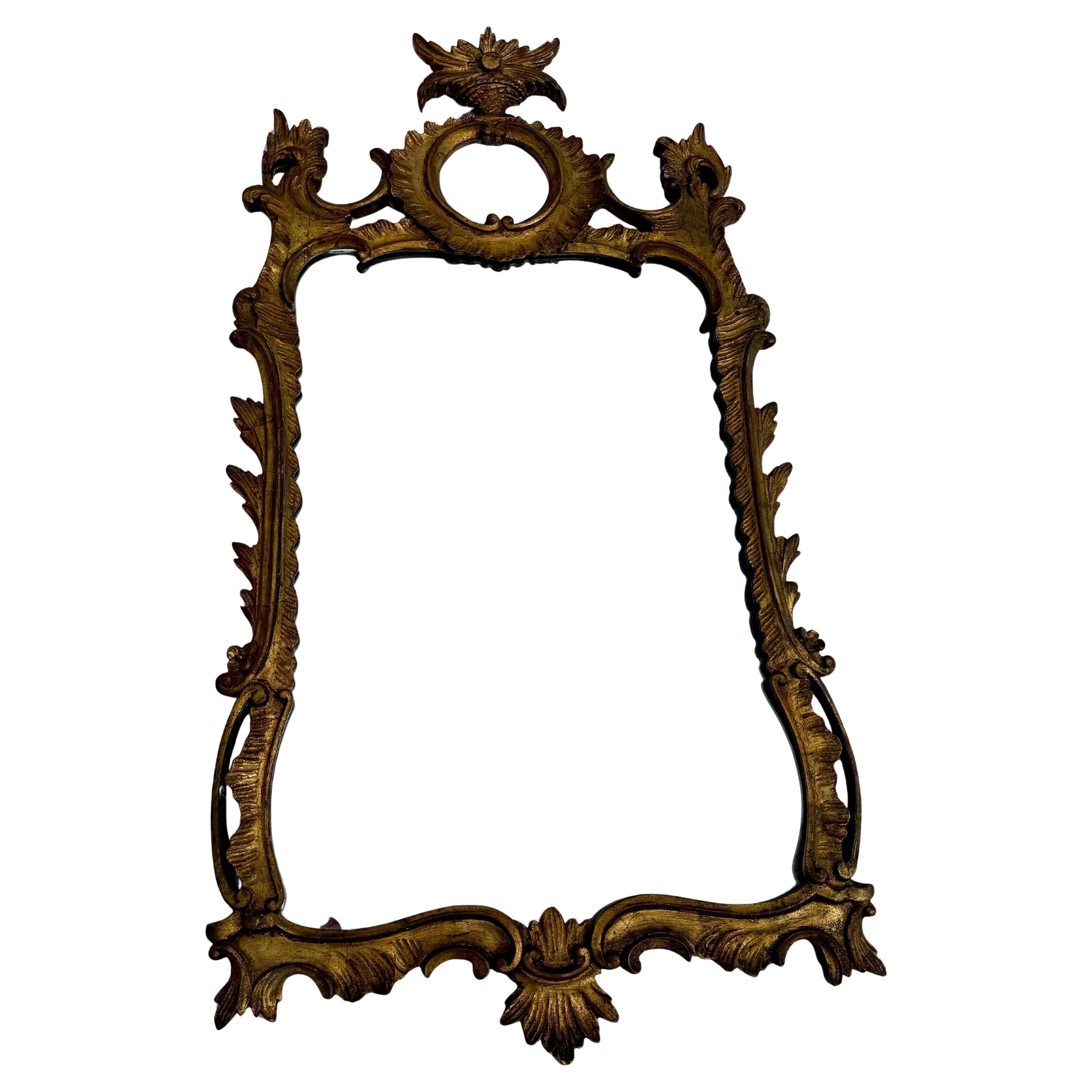Gold gilt carved wall Mirror from Italy with amazing patina. Charming classic Rococo style Italian mirror with floral details. Perfect piece to be used formally or informally in a hallway, bathroom, powder room, living room or bedroom. 
