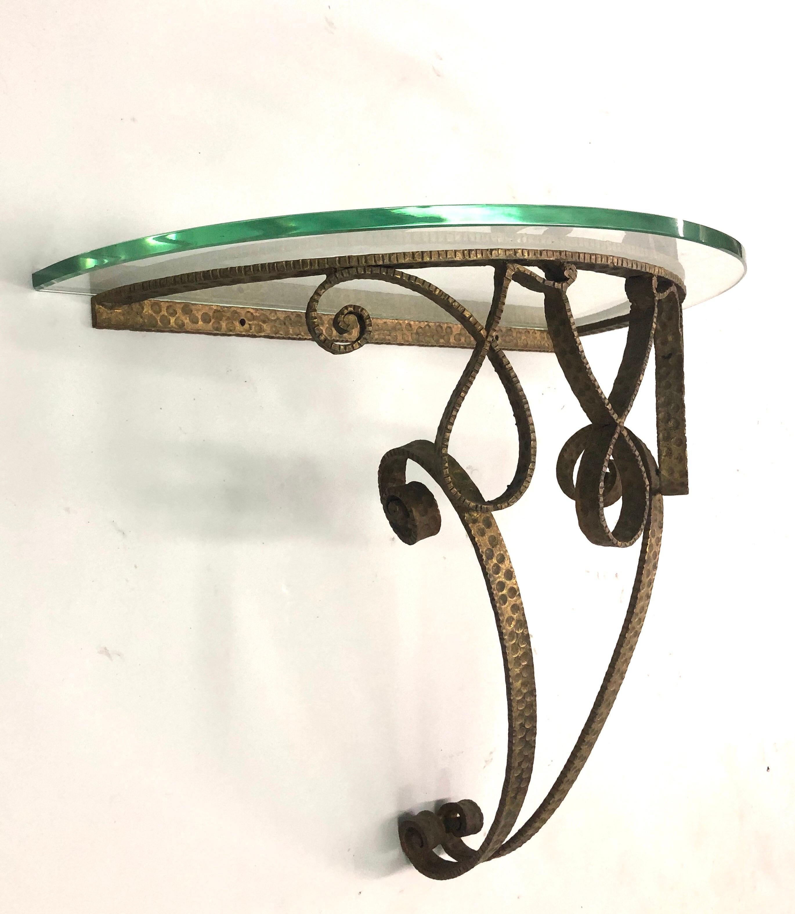 Italian Mid-Century Modern neoclassical gilt wrought iron demilune wall console by Pierluigi Colli. the iron is hand hammered.

Glass top rests on the iron base; stone or material of choice can easily be substituted. Iron Base dimensions only: H