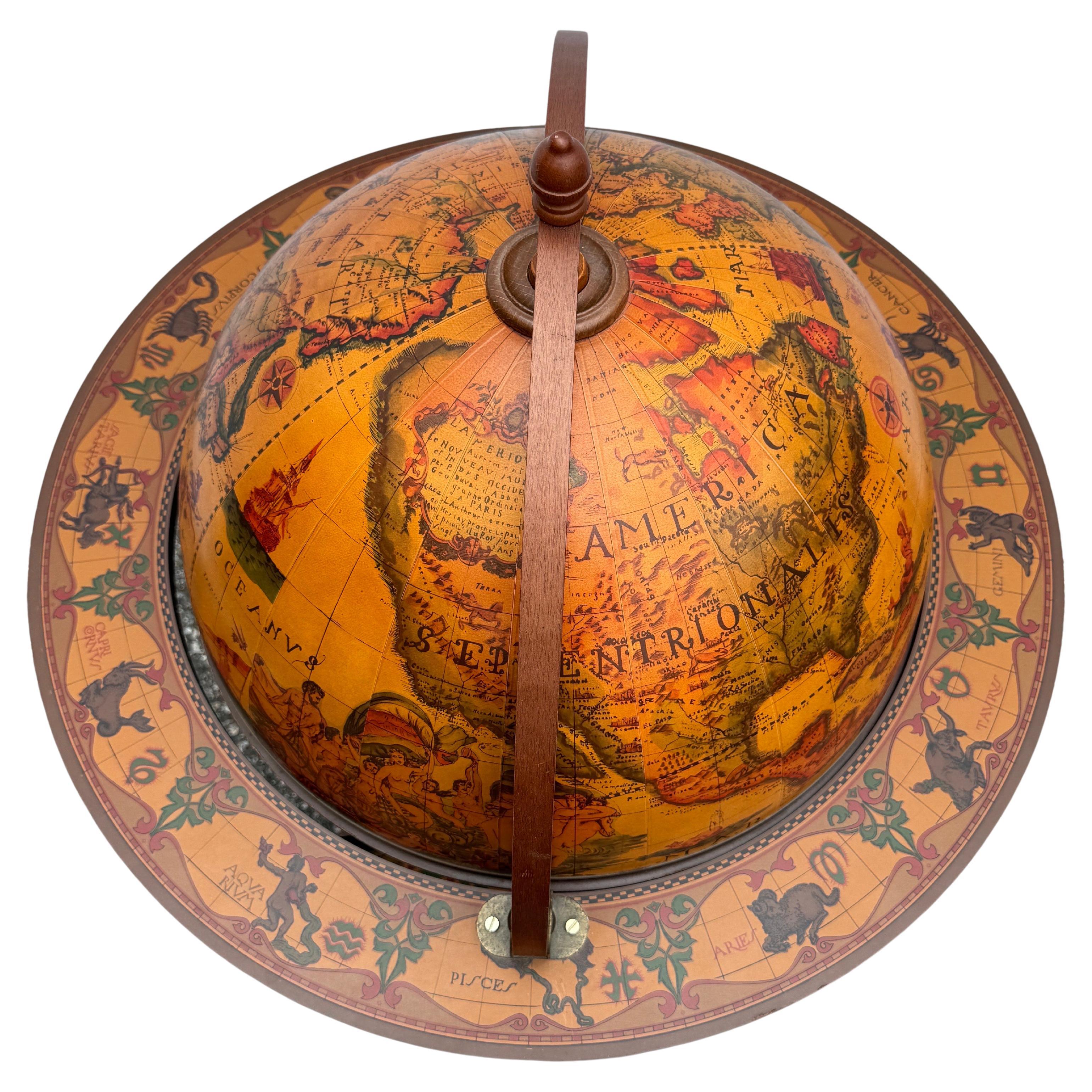Impressive Italian dry bar from the 1960’s is perfect for adding a touch of classic European flair to your home. The globe is quite detailed with a paper decorated picturesque world map as well as zodiac signs around the frame. The piece is made of