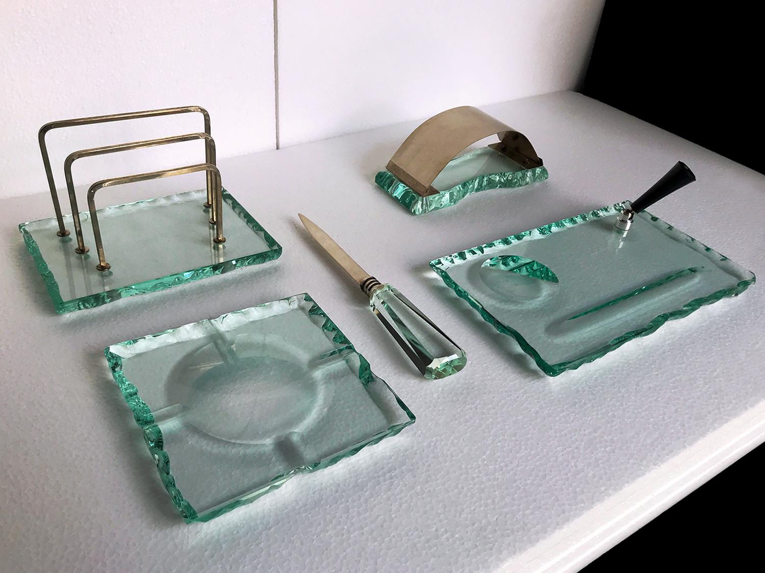 Stunning and rare crystal desk set produced by Fontana Arte in the 1950s and attributable to the design of Pietro Chiesa.

All items are handmade using thick glass colored 'green nilo' chiseled with rough edges, characteristic of the production of