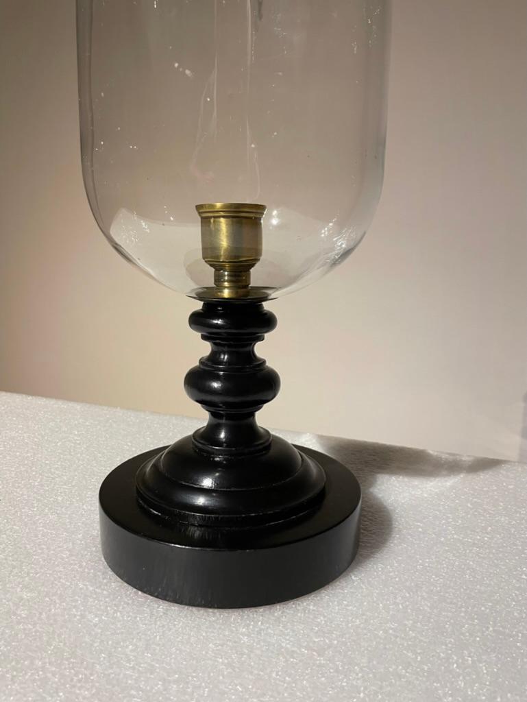 A very handsome Neoclassical style Italian photophore or hurricane lamp on a black lacquer turned wood base. With brass candle holder and hand blown glass shade. Mid 20th century, a modern interpretation of a classic form. 
Bobeche is stamped 'Made