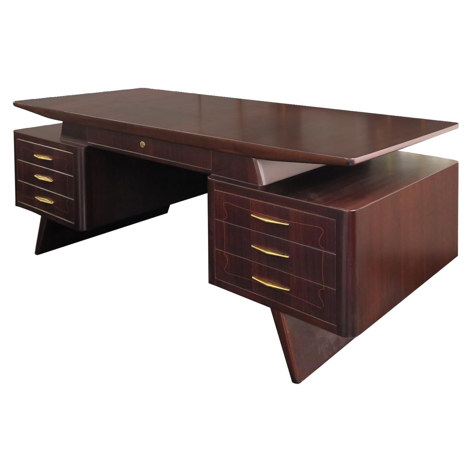 This stunning Italian Mid-Century Desk is crafted in Indian Rosewood with a satin finish. The piece features a floating top, with a center drawer and six side drawers.  A delicate fruitwood rectangular inlay is seen on the top in addition to the