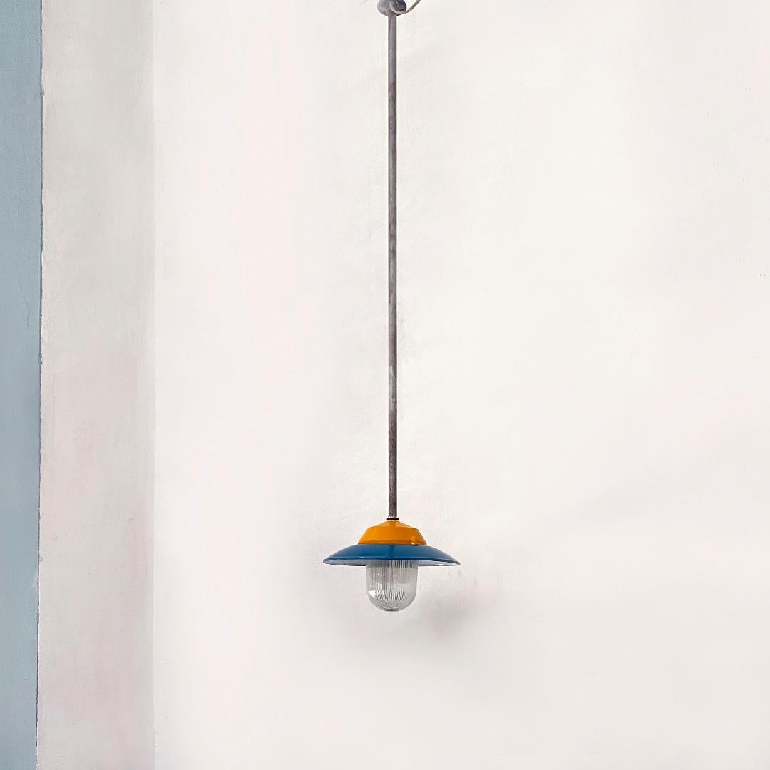 Italian mid-century industrial metal colored chandelier by Palazzoli, 1950s
colored chandelier with yellow metal tubular lampshade with blue disc and glass bell.
Produced by Palazzoli in the 1950s.

Good condition, plant checked.

Measures 30