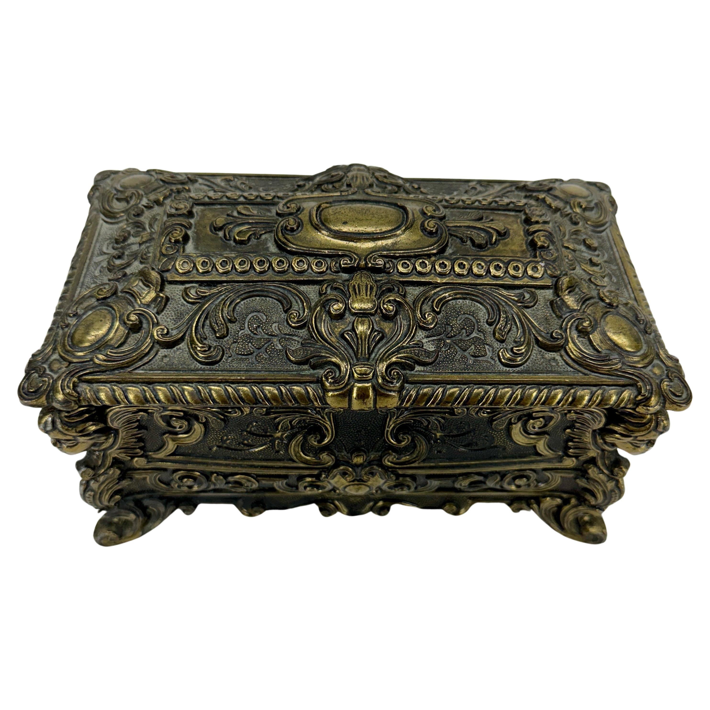 Charming Italian box with Cherubs and Rococo decorations perfect for jewelry or other collectables. This box features intricate baroque and Rococo detailing including cherubs on the corners. The box, lined in red fabric, is very sturdy, closes