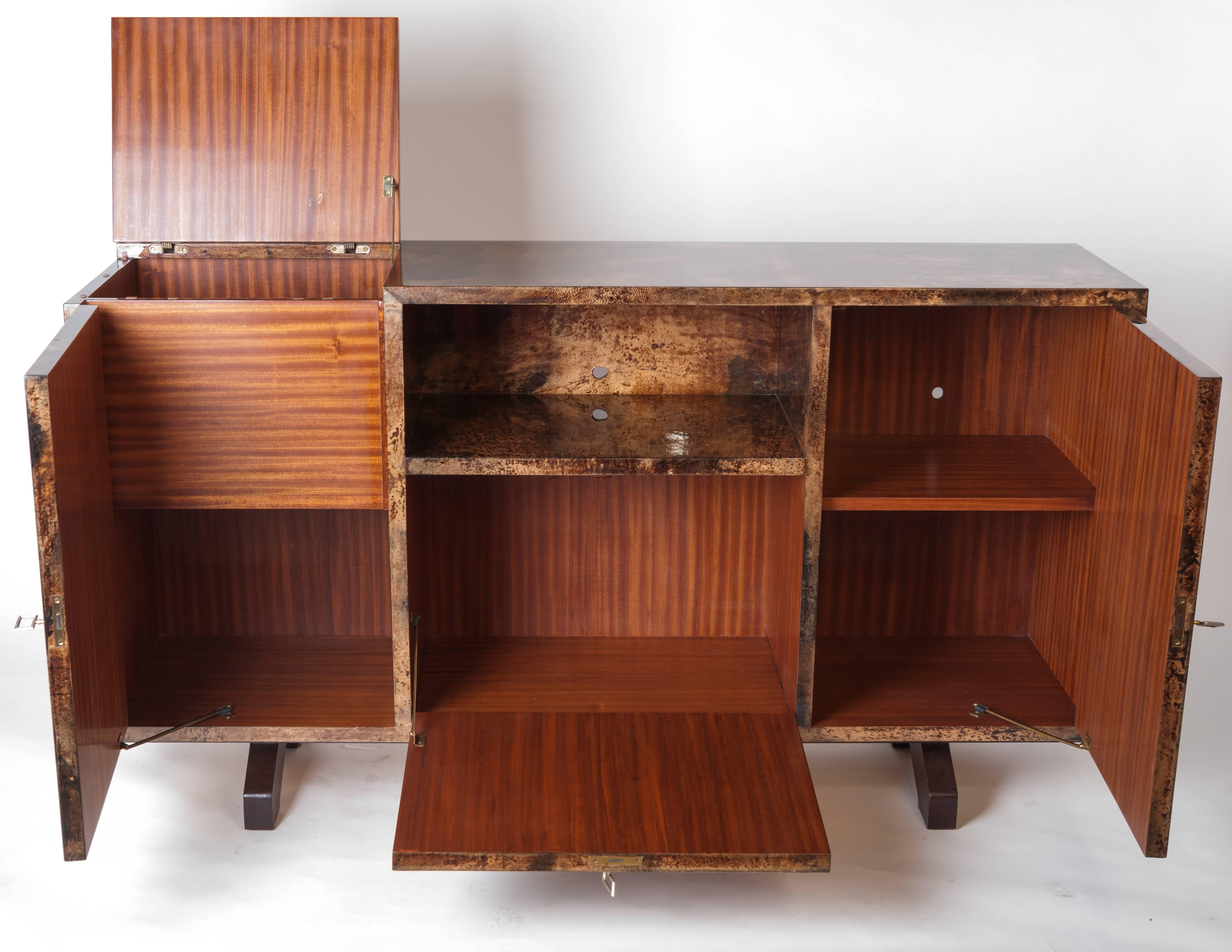 A very elegant and hard to find sideboard and bar by the famous designer Aldo Tura.

Italian designer and manufacturer Aldo Tura, born in 1909, opened his furniture company in 1939 in Lombardy. His works moved between Art Deco and Modernism. Tura
