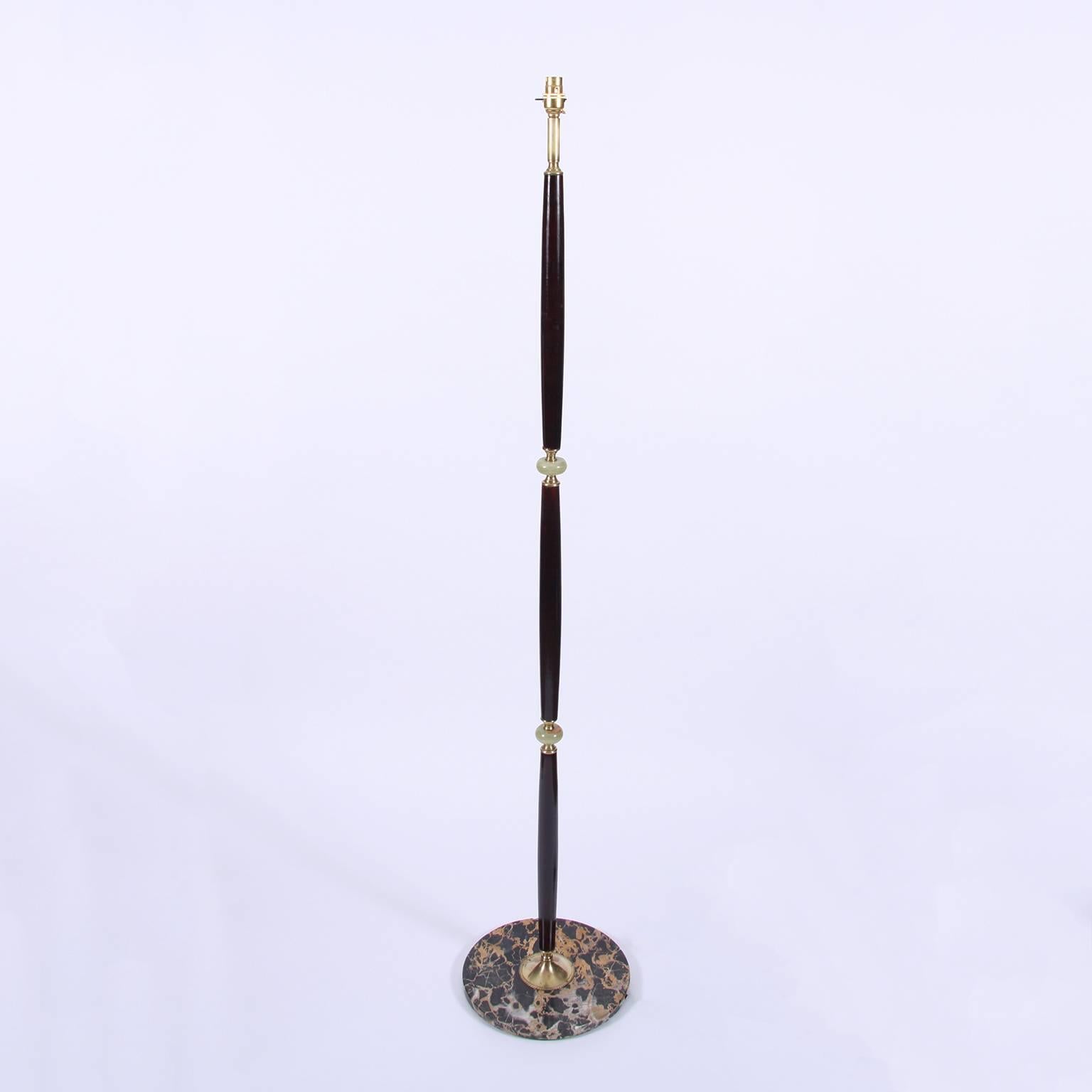 A stunning midcentury Italian floor lamp with lacquered wood sections interspersed with pale green alabaster. Dark marble base with brass detailing. There is slight pitting to some of the brass on the base. Otherwise this lamp is in fantastic