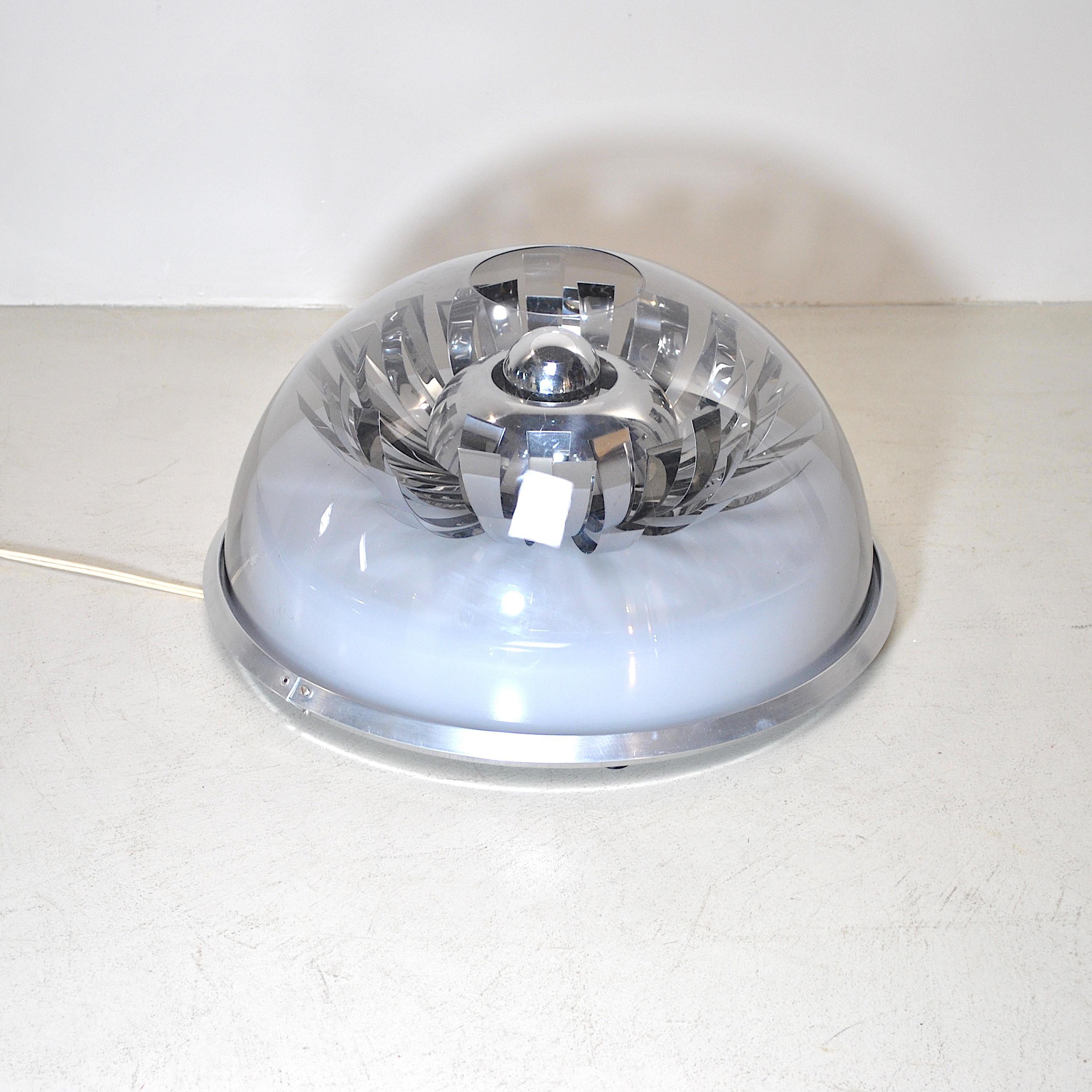 Space age floor lamp with plastic cap and chromed steel petals.