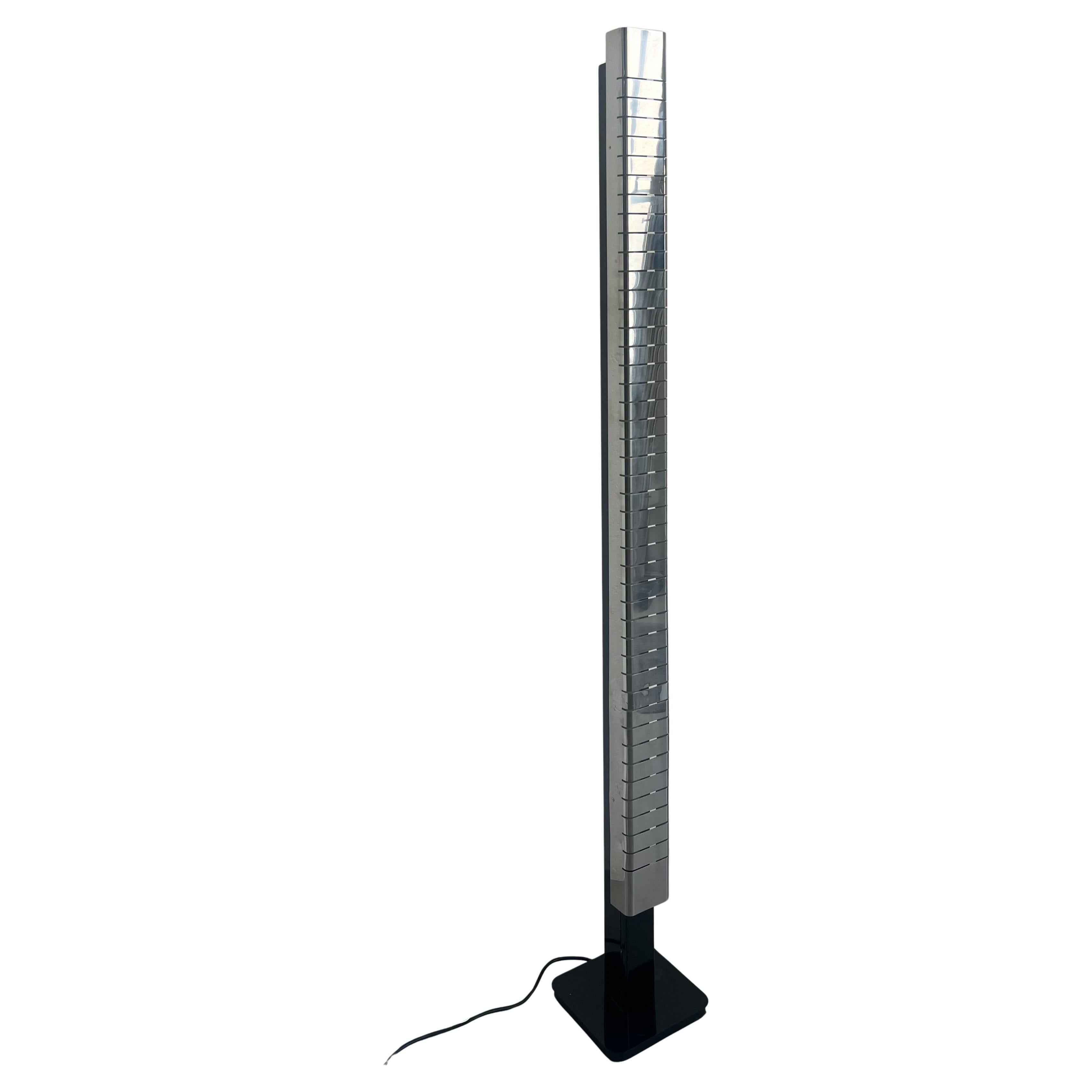 Italian Mid-Century Lamperti floor lamp, sculpted in chrome, 1960s.  The chromed monolithic structure of this floor lamp is built out of a continuous metal sheet column, with series of incisions at regular intervals from top to bottom. When switched