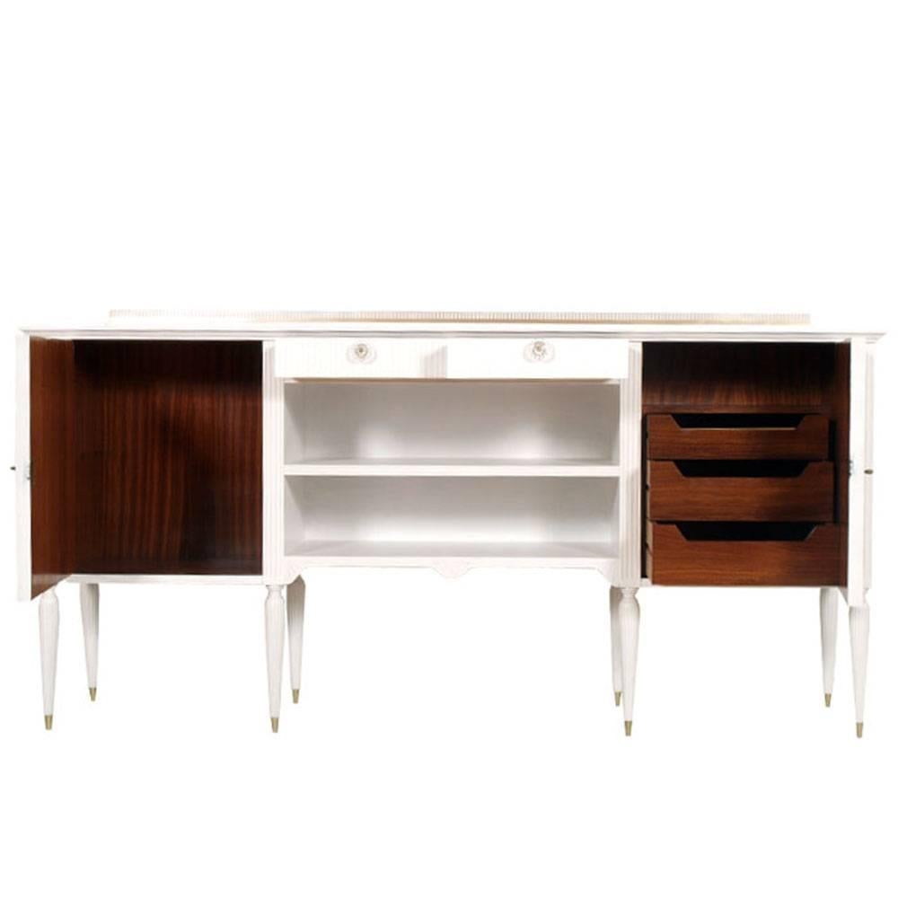 Vintage design sideboard from the 1950s by paolo Buffa for Permanente Mobili di Cantù,  in lacquered beech: with two doors with frames and oval central golden reliefs; one with three internal drawers and the other with a large internal compartment;