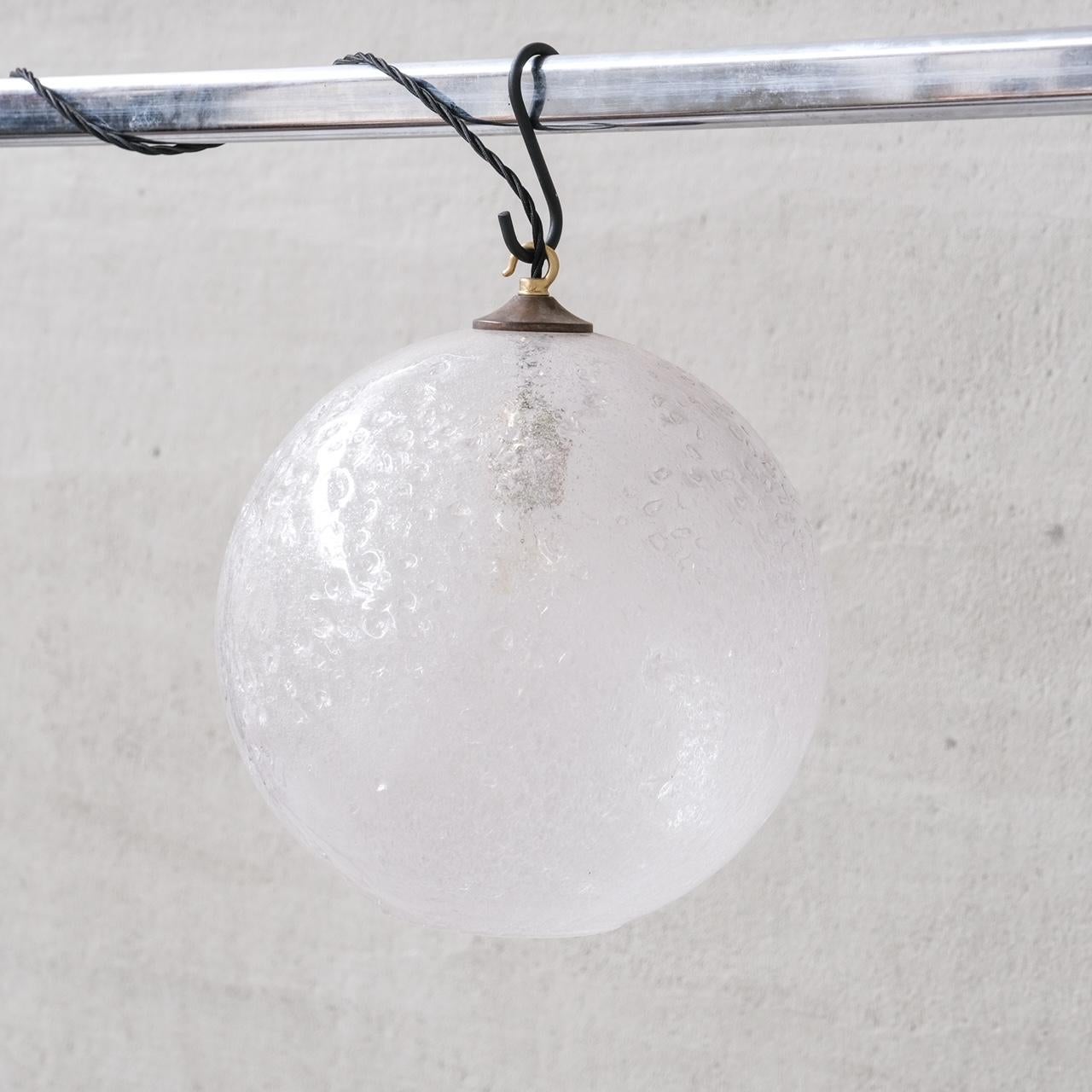Unusual large murano glass pendant lights.

Italy, c1960s.

Unusual glass, semi-opaque, crater like finish reminiscent of a moon.

PRICED AND SOLD INDIVIDUALLY.

9 available at the time of listing.

No chain or rose was retained, however they are