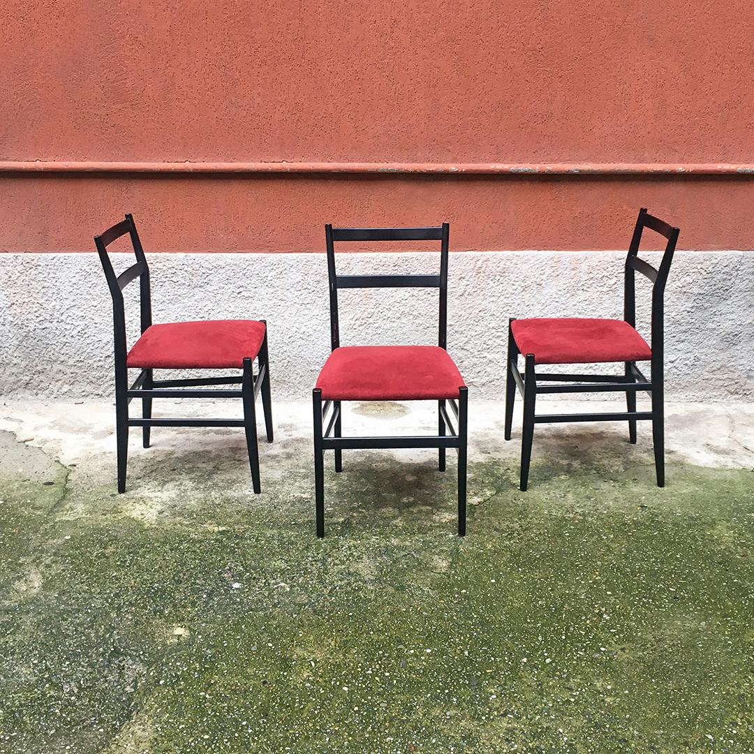 Italian midcentury Leggera chairs by Gio Ponti for Cassina, 1951
Padded seat upholstered in red fabric and black stained beech frame Leggera chairs. 
Design by Gio Ponti, for Cassina, 1951.
The Leggera chair represent one of the most famous icons