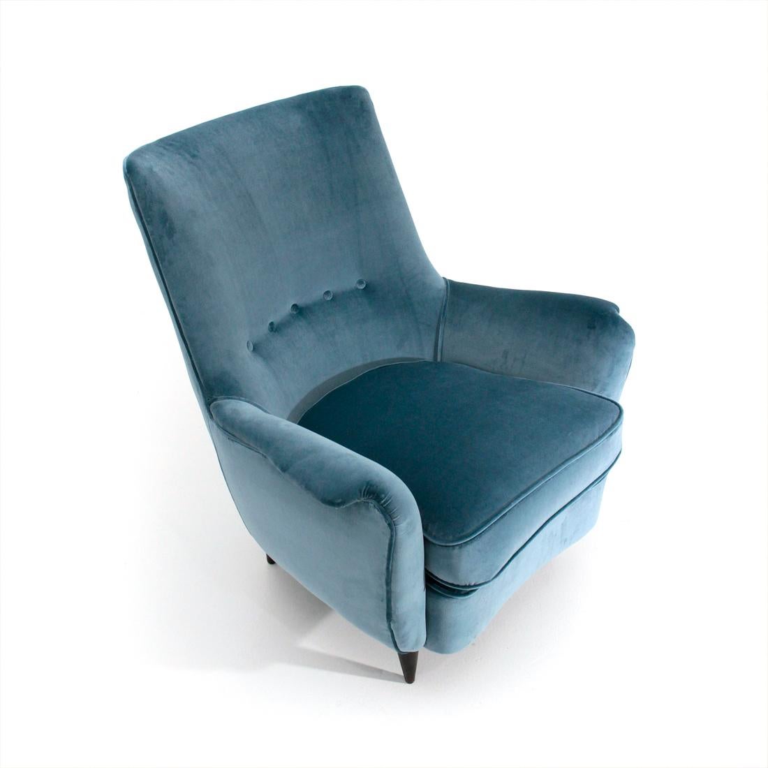 Italian manufacture armchair produced in the 1950s.
Wooden frame padded and lined with new light blue velvet fabric.
Seat with padded cushion and removable cover.
Stitched back with buttons.
Legs in conical shaped wood, painted in brown.
Good