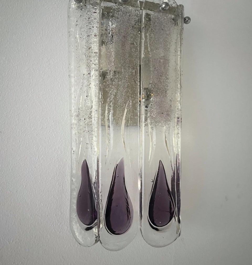 Unique and beauty Italian Lilac Murano glass Wall Sconce from 1970s. This fixture was designed and manufactured during the 1970s in Italy by Mazzega.
This Wall Sconce is equipped with 2 light sockets E14. A professional electrician has checked and
