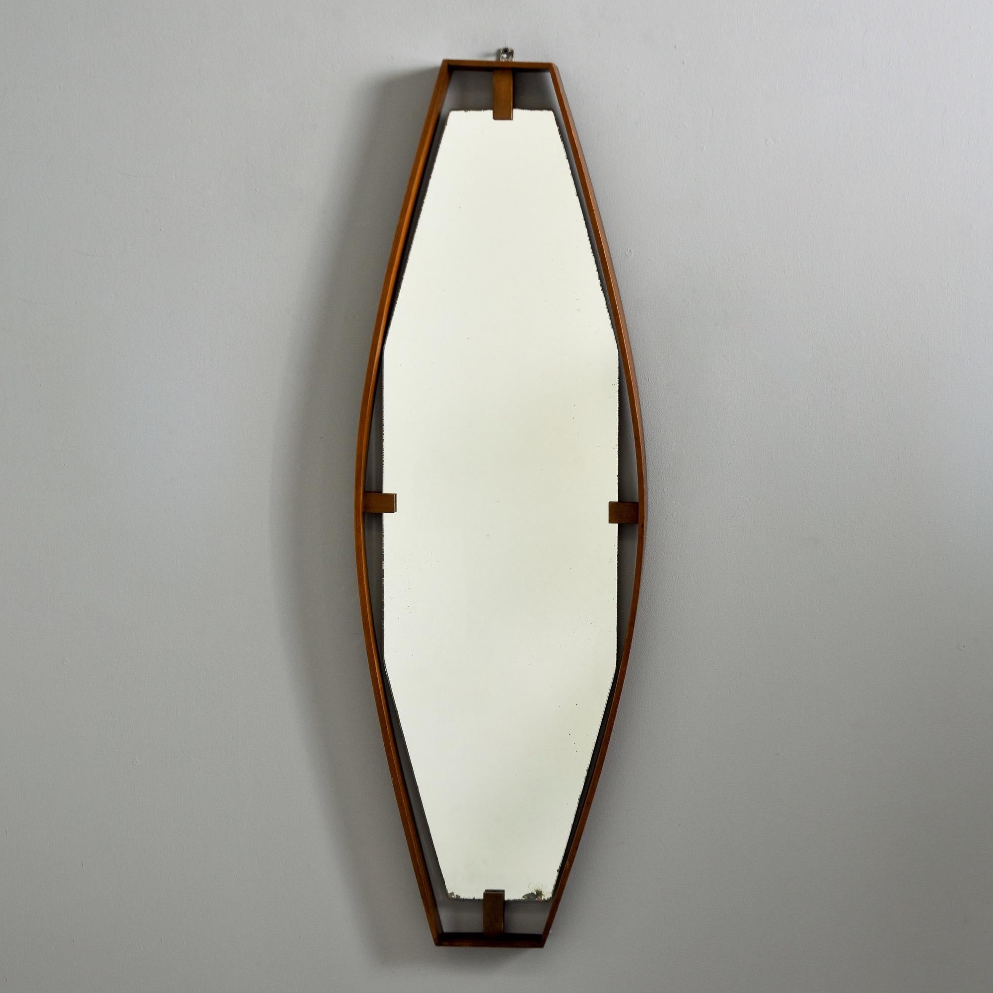 Found in Italy, this circa 1960s unusual long, slender mirror appears to float inside a narrow mahogany frame. Unknown maker. Some loss of silvering to mirror edges - very good overall vintage condition with minor scattered surface wear. 
Actual