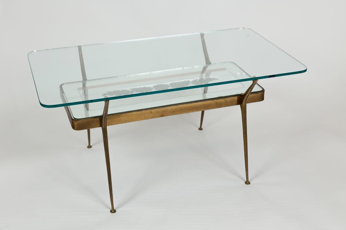 A stunning two tiered angled brass table by Cesare Lacca, shown with its orginal inset etched leaf glass plateau attibuted to Fontana, floating glass top with rounded edges mimic the shape of the base of the table, top glass plateau not