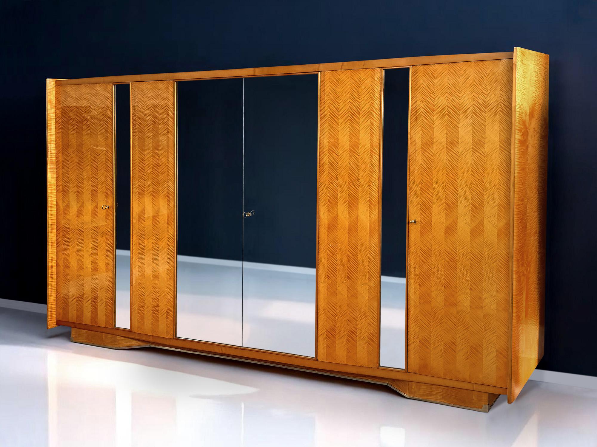 This exceptional six-door wardrobe, crafted in the 1950s by Vittorio Dassi, stands as a rare and refined testament to Italian mid-century design.
Part of a complete bedroom suite — which also includes a double bed and a vanity dresser with mirror —