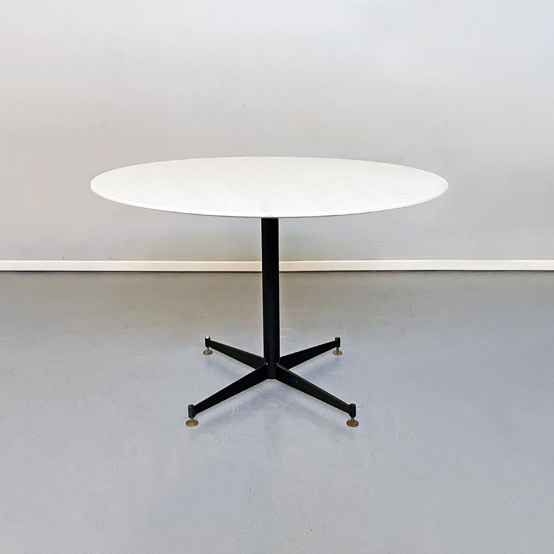 Italian mid-century marble, metal and brass dining table, 1950s
Dining table with round statuary marble top, with beveled edge and surface entirely re-polished and restored. Four-spoke leg in black metal and brass tips.
Excellent condition, an old