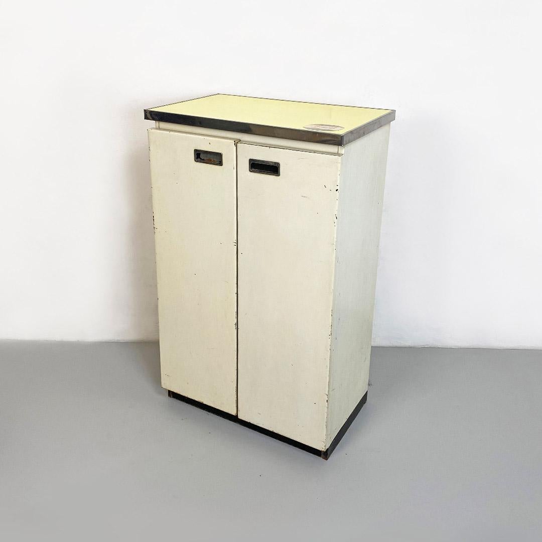 Italian Mid-Century Modern metal and laminate cabinet with two doors and metal shelves, 1960s
Metal cabinet or shoe cabinet, with two doors, with original yellow formica top of the time. Black base with white structure, hinged doors and chrome