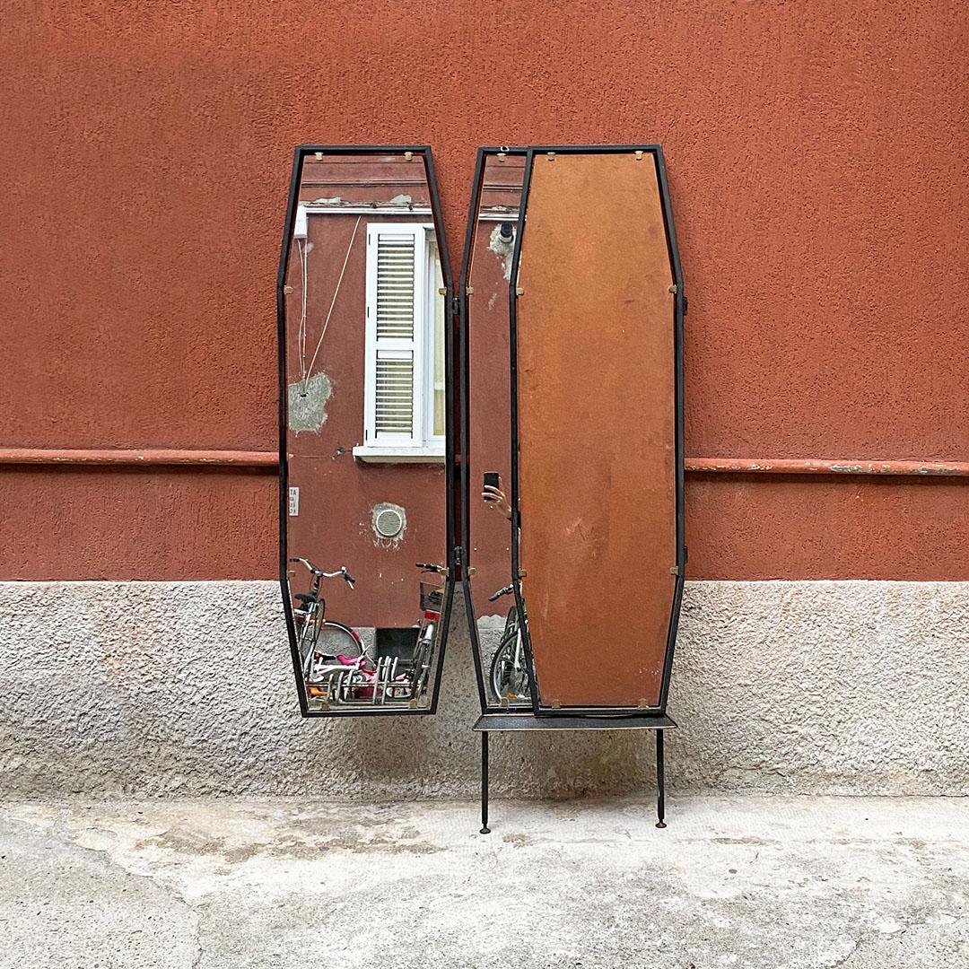 Italian mid-century metal octagonal frame with closable doors wall mirror, 1950s
Floor mirror with three octagonal shaped doors and square section metal frame, with two central legs and brass tips and details along the structure. Tilting side