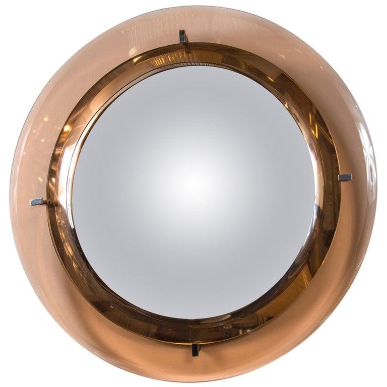 Gorgeous circular salmon colored floating crystal beveled glass frame mirror with original looking glass by Cristal Arte.

 