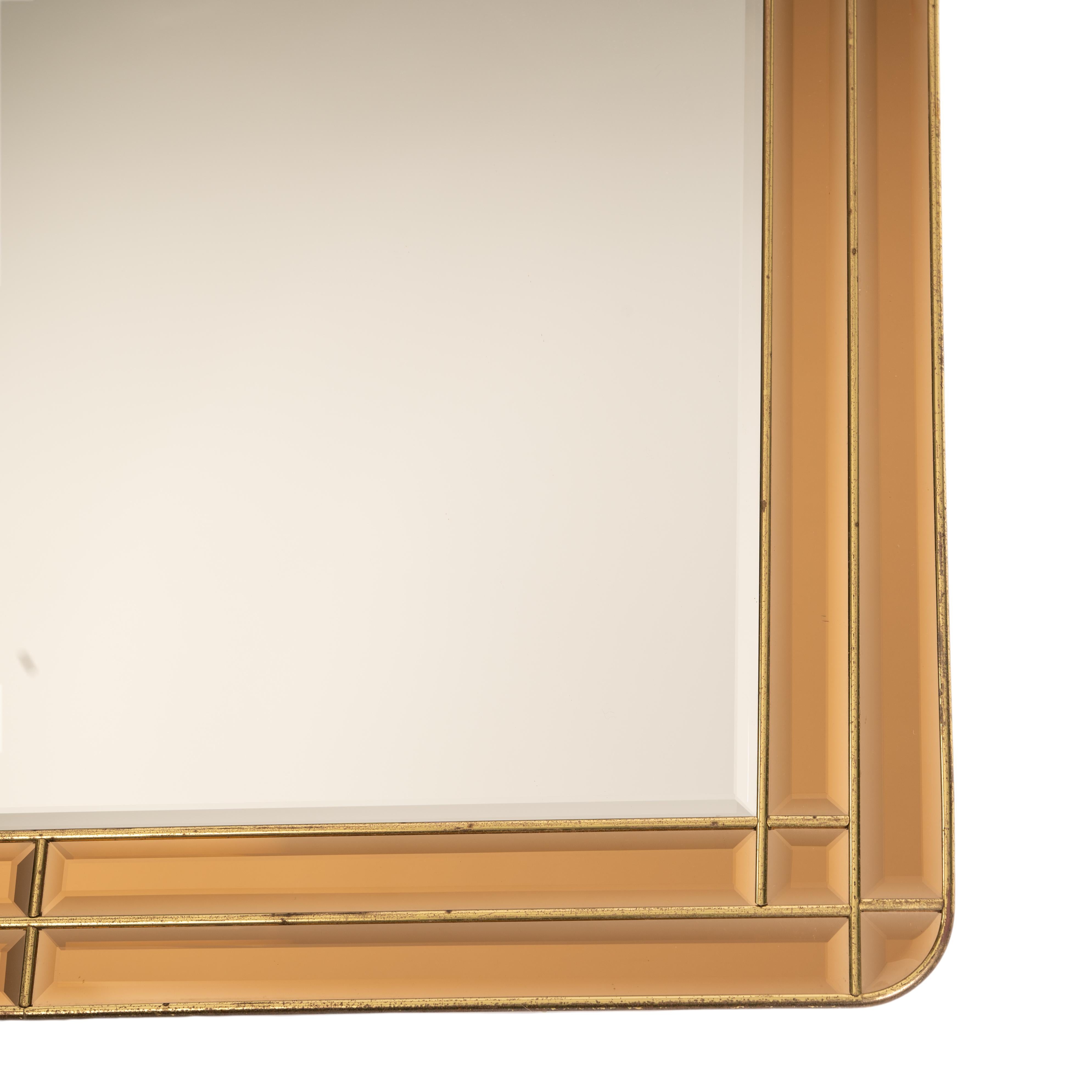 Mid-century Italian mirror with amber-colored glass frame. 
All surfaces have a 1cm thick facet and are edged with a fine brass bar.
This creats a different refraction of light and makes the mirror an eye-catcher.
Original, undamaged condition.