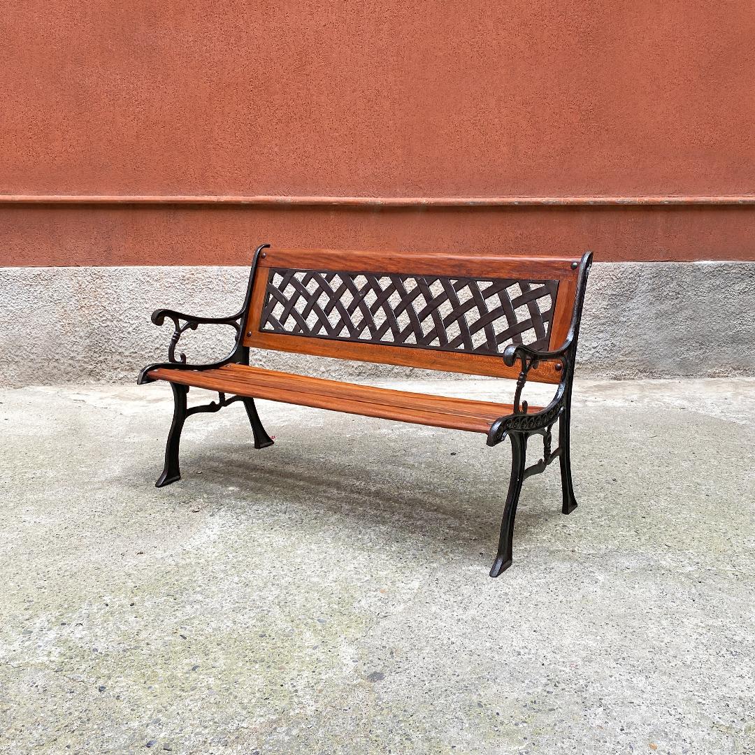 Italian Mid-Century Modern wood and cast iron outdoor bench, 1960s.
Bench in wood and cast iron, with slatted seat, curved cast iron armrests with decorations and backrest with central part also in cast iron.
1960s.
Excellent condition, fully