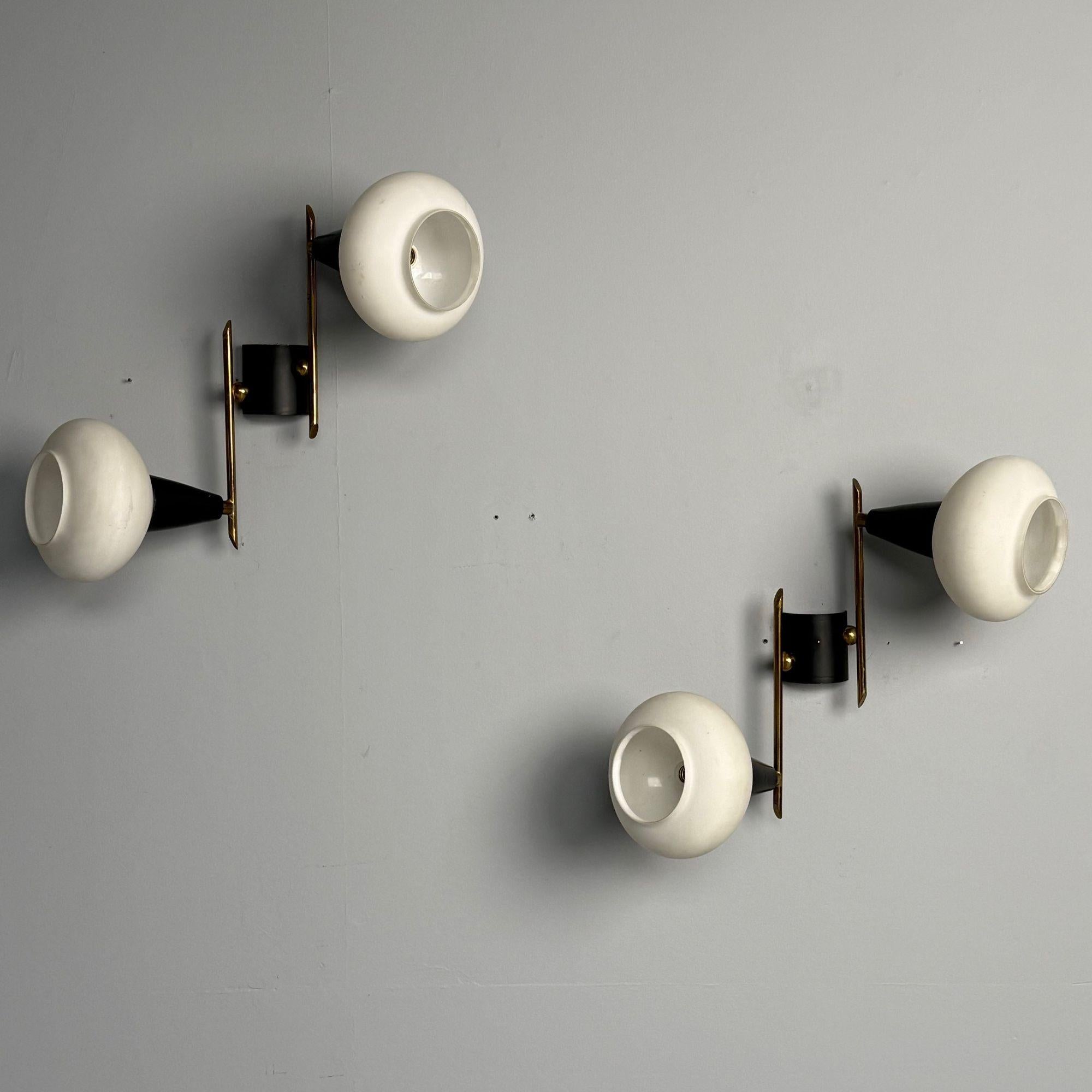 Italian Mid-Century Modern, Adjustable Wall Sconces or Wall Lights, Brass, Opaline Glass, 1960s

These modernist Italian sconces feature a sleek design with two black metal frames, giving them a contemporary edge. The adjustable patinated brass arms