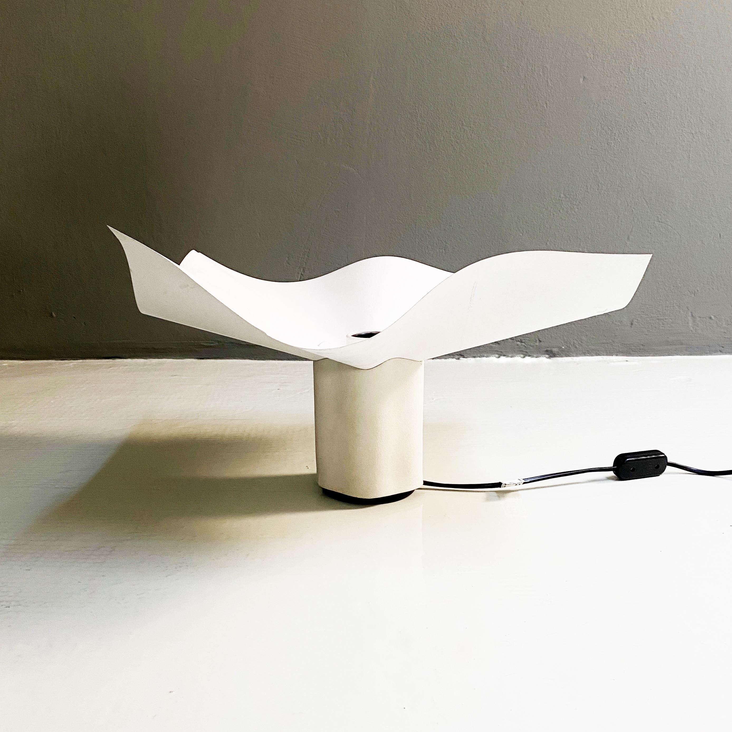 Area table lamp by Mario Bellini for Artemide, 1974

Floor lamp with ceramic base and white resin diffuser. Produced by Artemide and designed by Mario Bellini.
The lamp is exhibited at the MoMA permanent exhibition in New York and at the Victoria