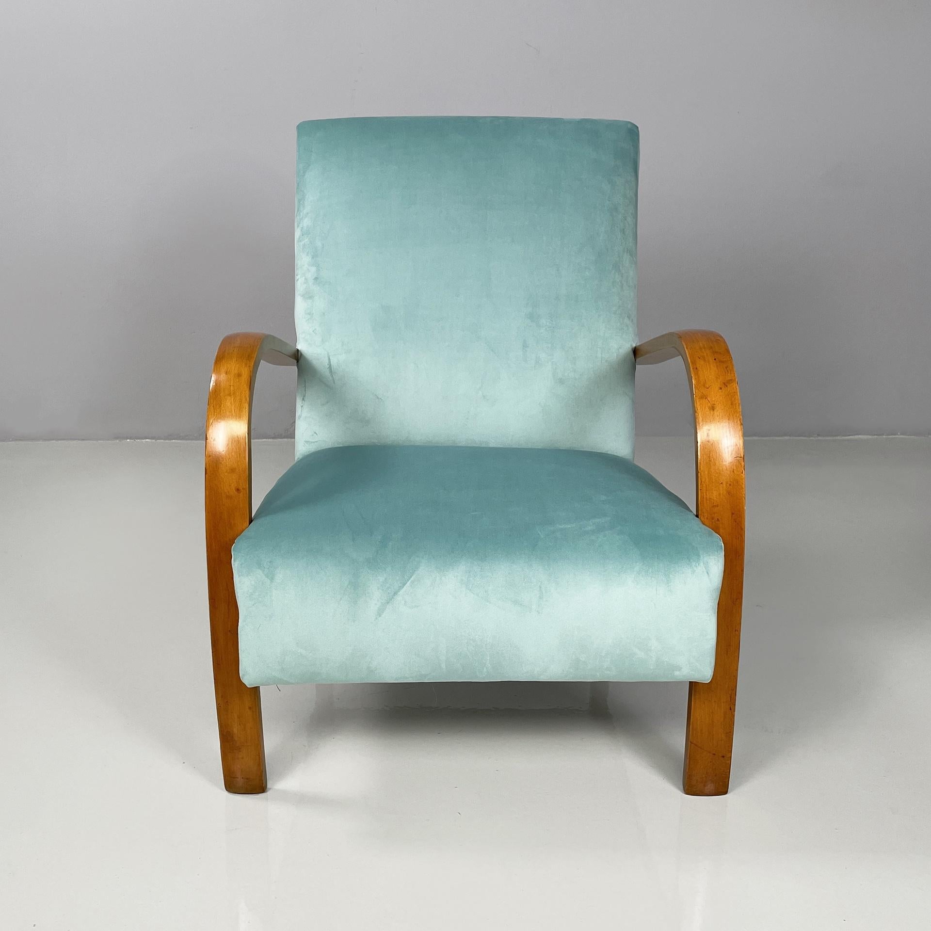 Italian mid-century modern armchairs in light blue and wood, 1950s
Pair of armchairs with square seat and backrest, padded and upholstered in bright blue velvet with round metal studs. The armrests are in curved wood. Square section wooden
