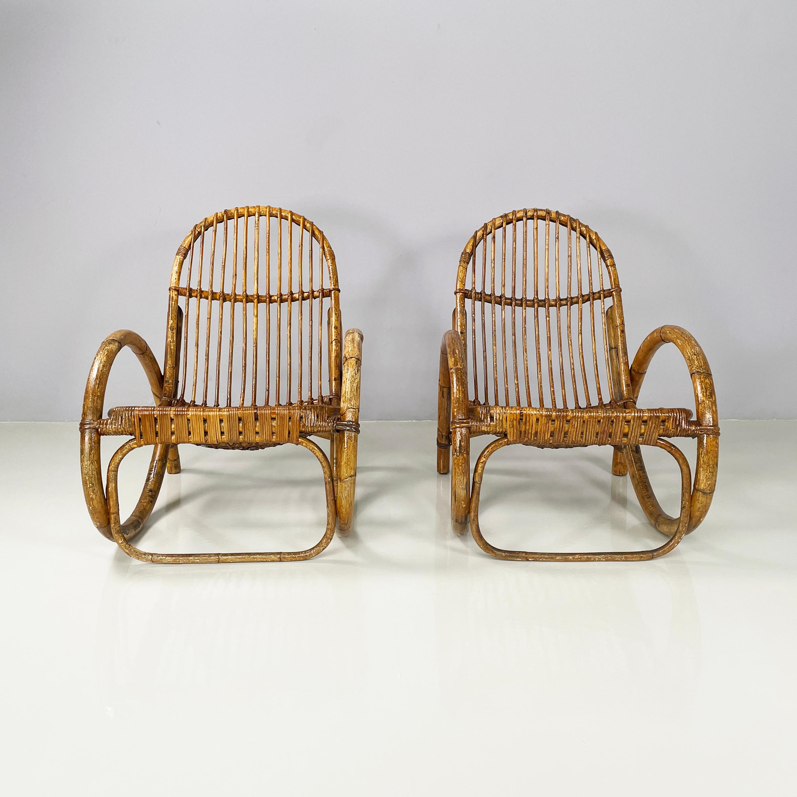 Italian mid-century modern Armchairs with armrests in curved rattan, 1960s
Pair of armchairs entirely in curved and woven rattan with rattan bands. The seat and backrest are made of curved rattan slats. Curved armrests. They can be used outside,