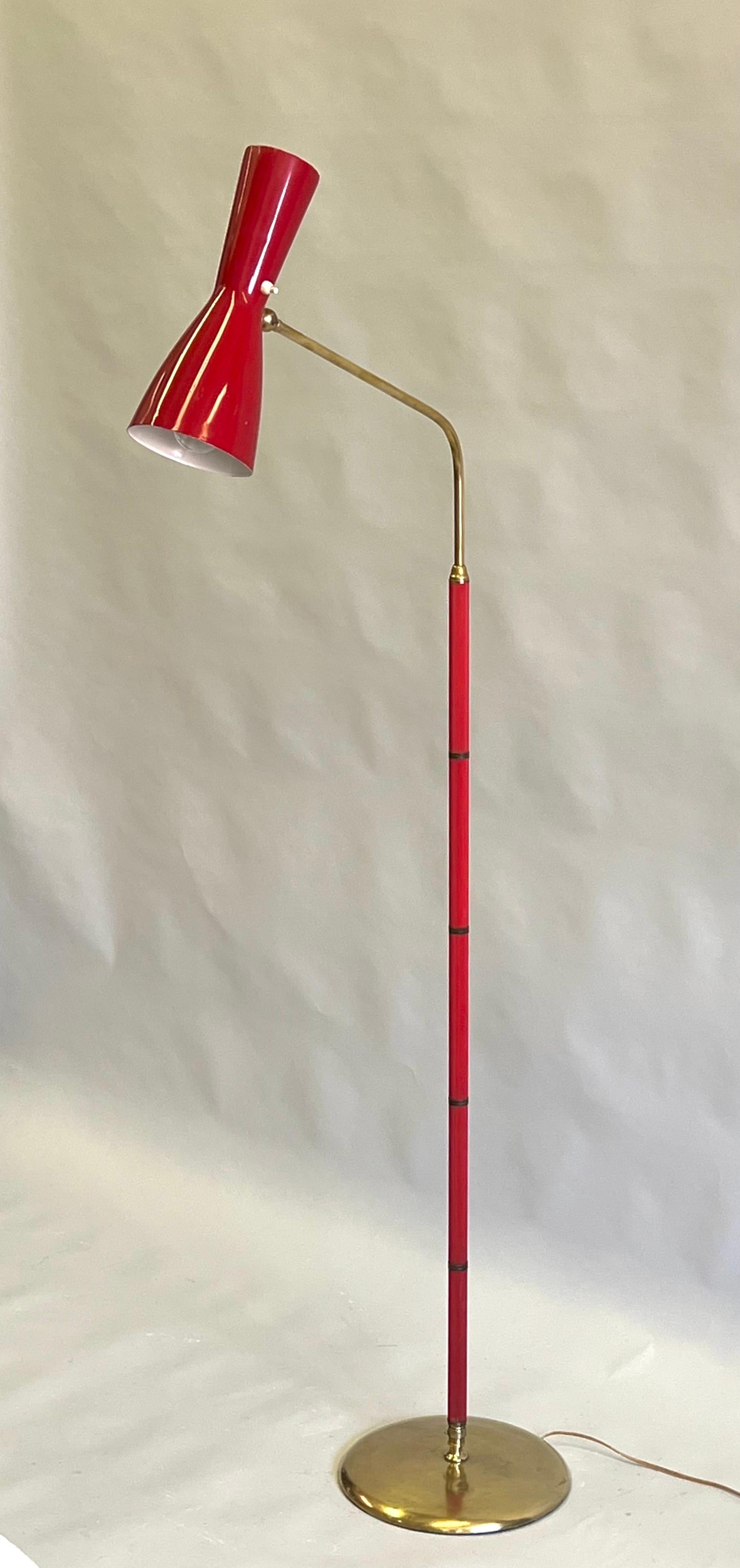 Rare Italian Midcentury Articulating Floor Lamp in Red Enameled Metal, Synthetic Red Rubber and Brass attributed to Vittoriano Vigano for the design firm of Arteluce. This is a functional and dramatic work of Italian engineering with original design
