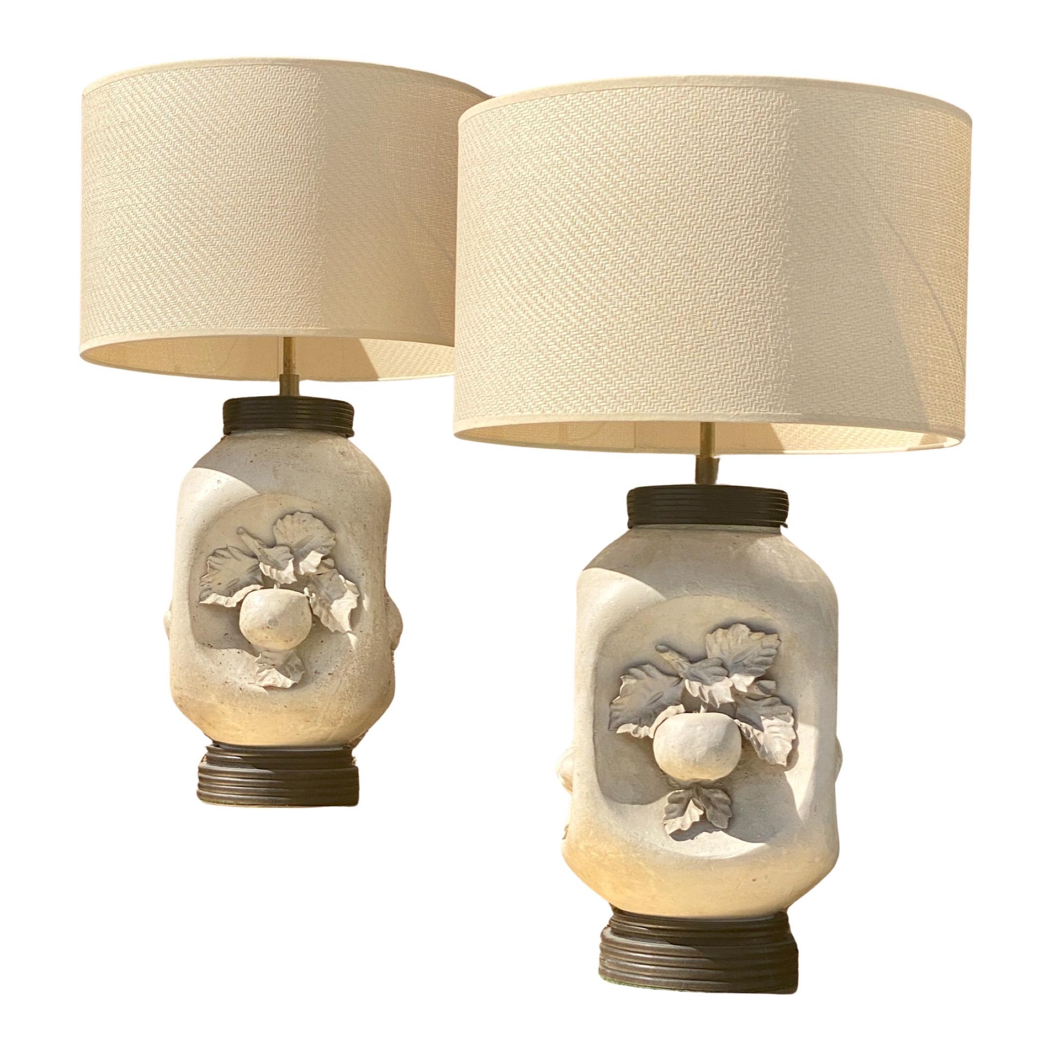 A really beautiful and rare pair of high end Mid-Century Modern lamps made in Italy in the 1950s. Matte bisque natural white color with black bases. Newly rewired with new cords and high end bronze color double sockets. Each lamp has four sides with