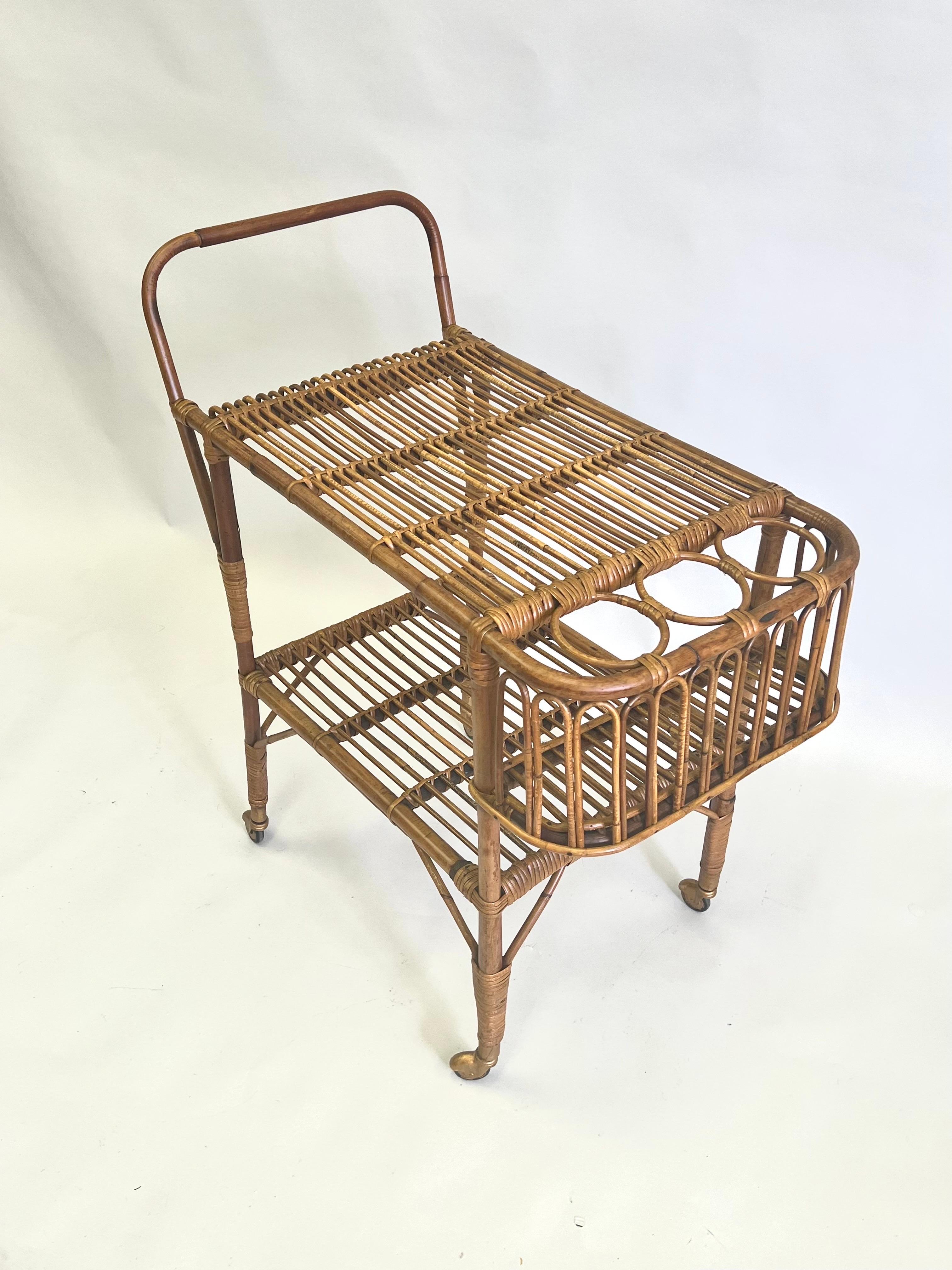 Rare and important Italian Mid-Century Modern rattan and glass bar or serving cart by Franco Albini. The piece is unique in linking traditional materials (rattan, bamboo) with an open, transparent aesthetic reflective of modernism. The stunning,