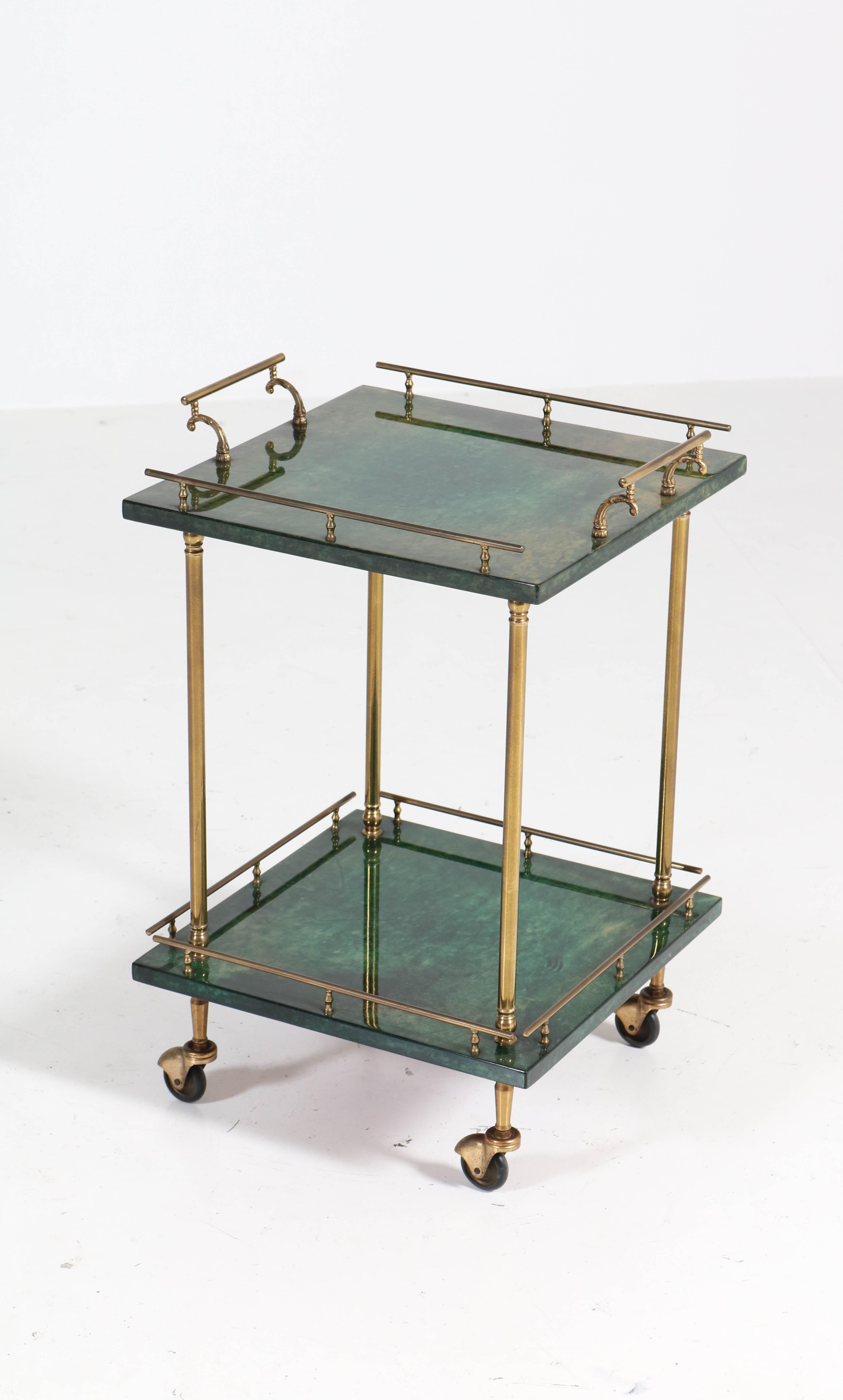 Elegant and rare Mid-Century Modern bar cart or side table.
Design by Aldo Tura Milan.
Striking Italian design from the 1960s.
Green lacquered goatskin with gilt brass.
In very good original condition with minor wear consistent with age and