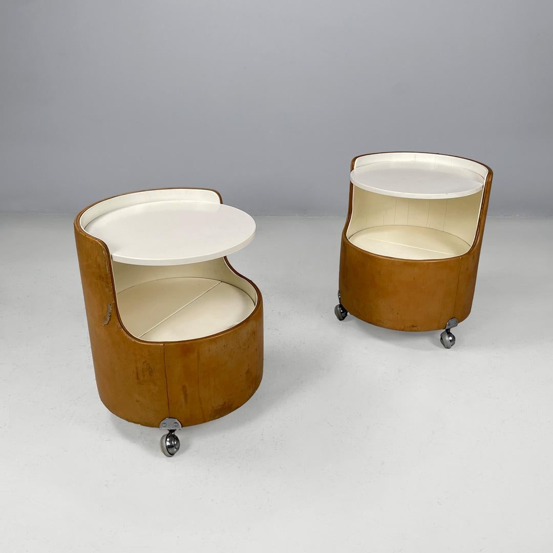Italian Mid-century Modern Bedside tables Lullaby by Luigi Massoni , 1960s
Pair of bedside tables model Lullaby with round base. The structure is made of wood covered in leather and has two shelves. The lower support surface hides a container