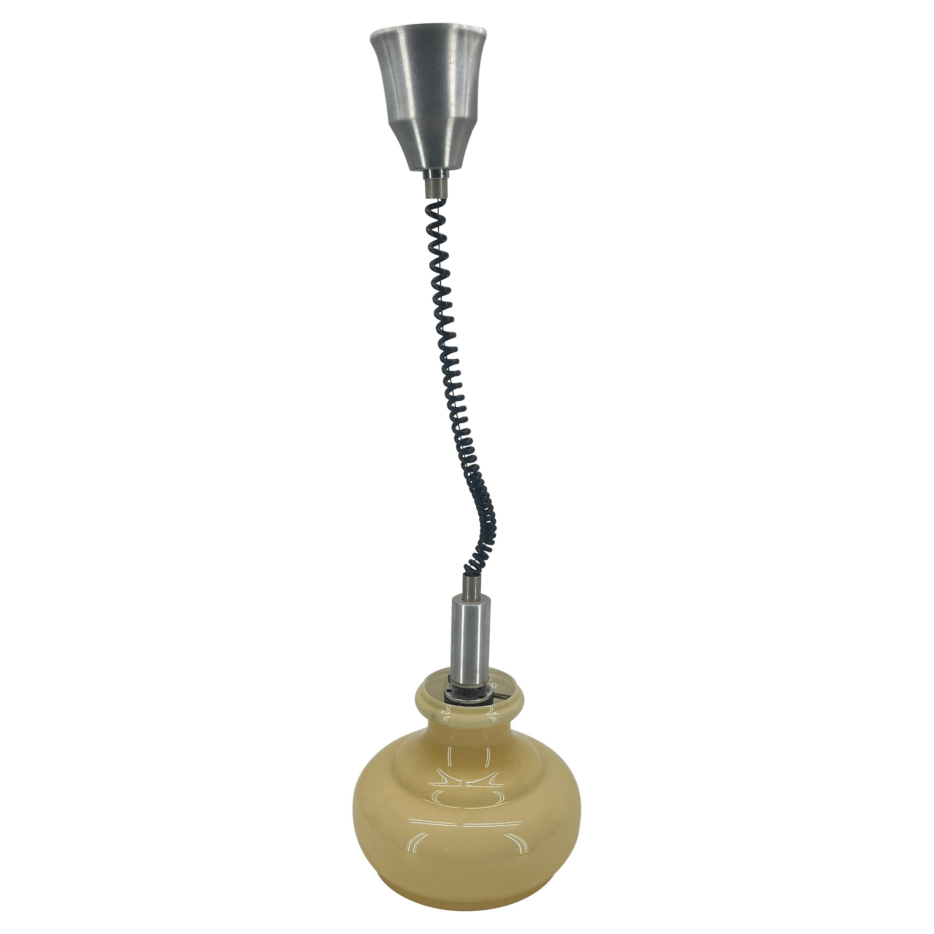 Italian blown glass pendant light with chrome accent and vintage black spiral cording. This ceiling fixture light will glow through it's milky golden tiered glass shade. The curved and graduated design make this pendant special in any area of the