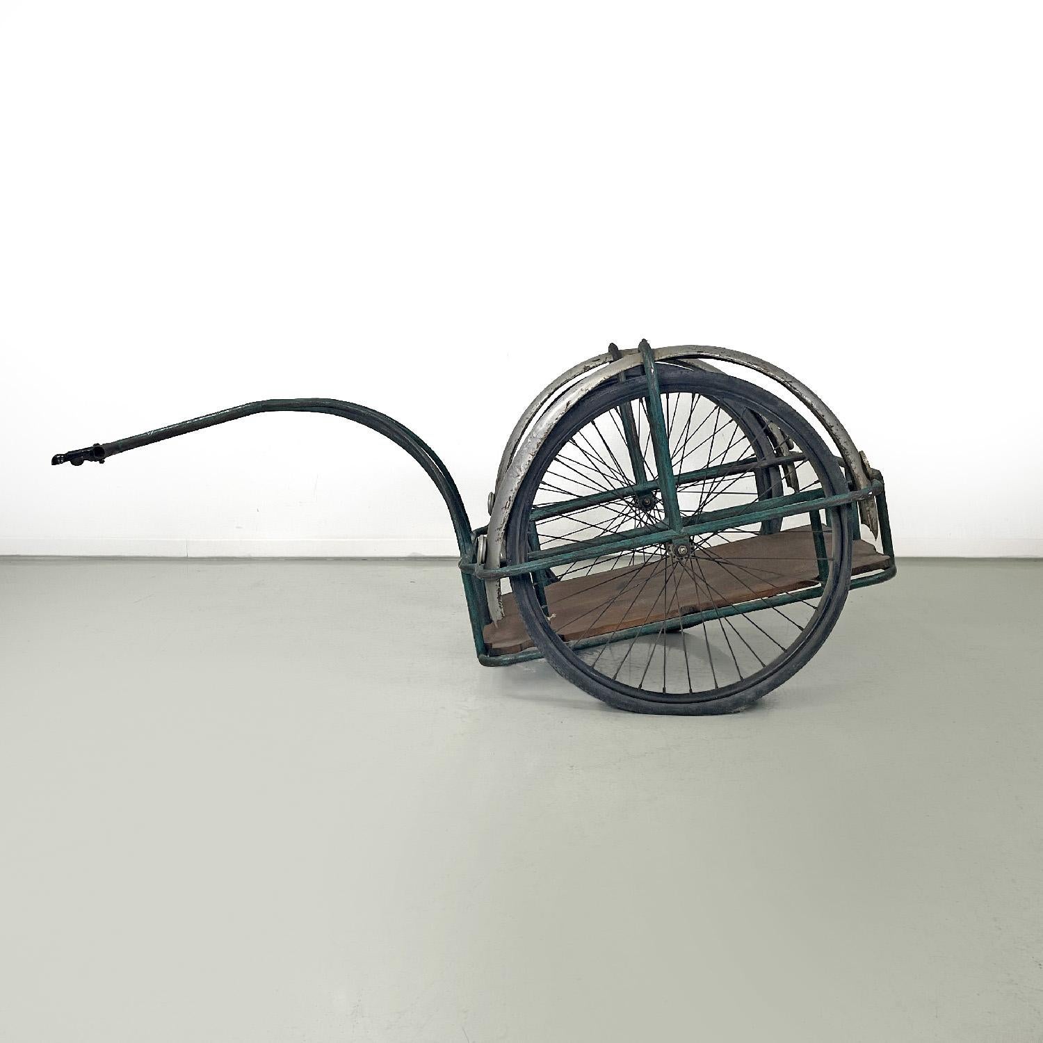 Italian mid-century modern bicycle trailer in metal and wood, 1960s
Bicycle trolley, trailer or cargo bike with green painted metal structure. The structure is made up of an arm that attaches to the bicycle frame at one end, while the other end