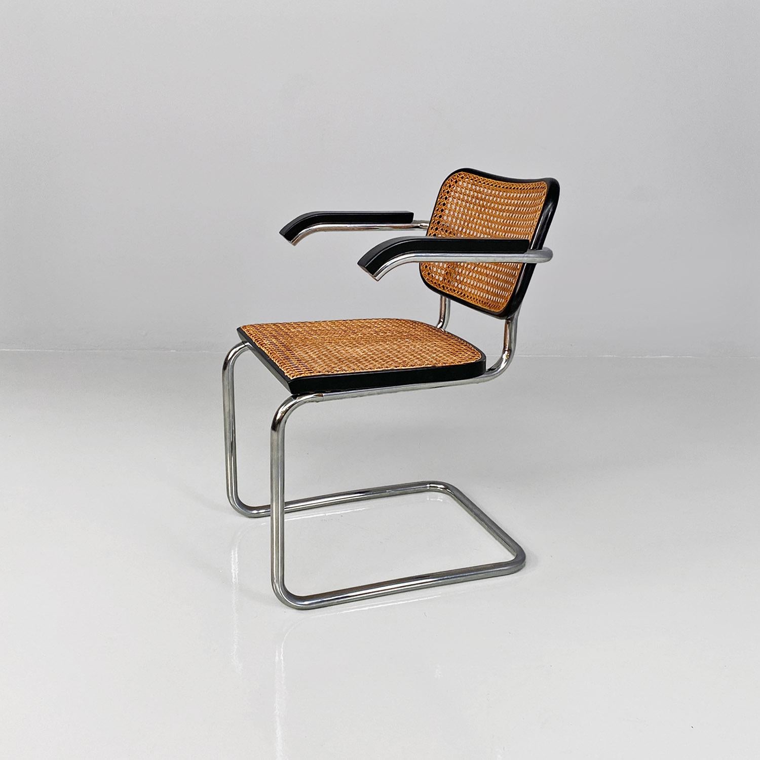 Italian mid-century modern set of 8 black wood, steel and Vienna straw Cesca chairs by Marcel Breuer for Gavina, 1960s.
Set of 8 Cesca model chairs with armrests, with seat and back in dark Vienna straw with black painted wooden profiles. The