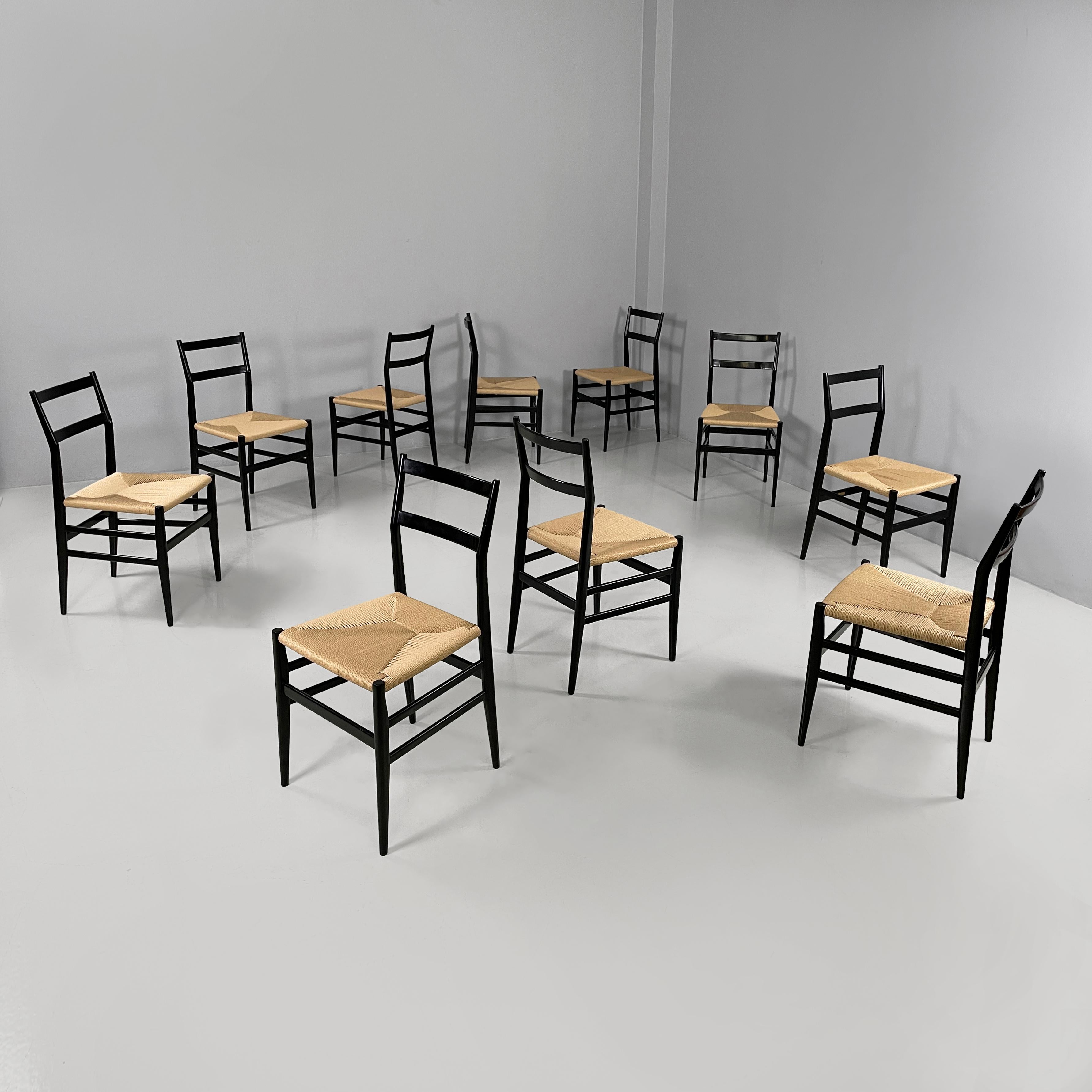 Italian mid-century modern black chairs Leggera by Gio Ponti for Cassina,  1960s
Set of ten chairs model Leggera with square straw seat. The round section structure and the backrest with curved slats are in black painted wood. The round section legs