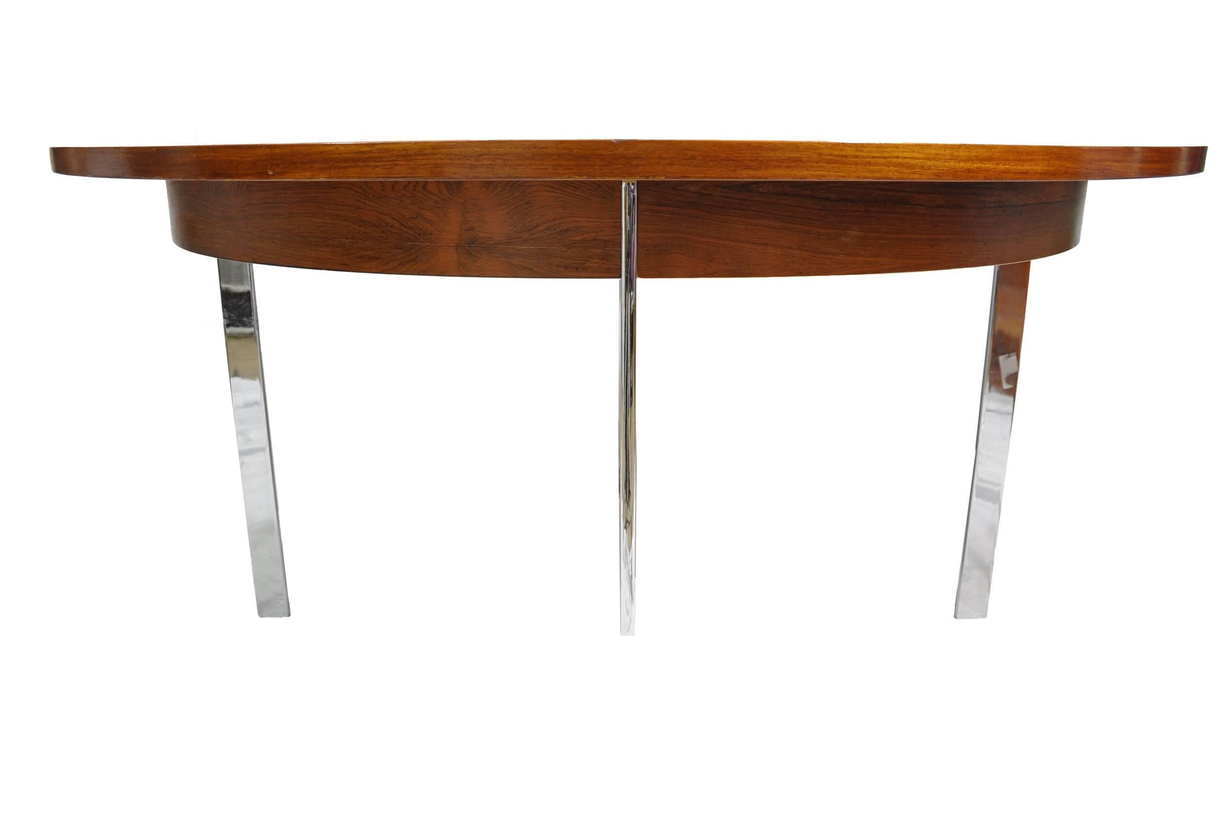Italian Mid-Century Modern chrome and wood circular dining table veneered in black limba from West Africa. Table set includes original chrome chairs (four) with faux leather pad seats, mid 1960s-1970s.