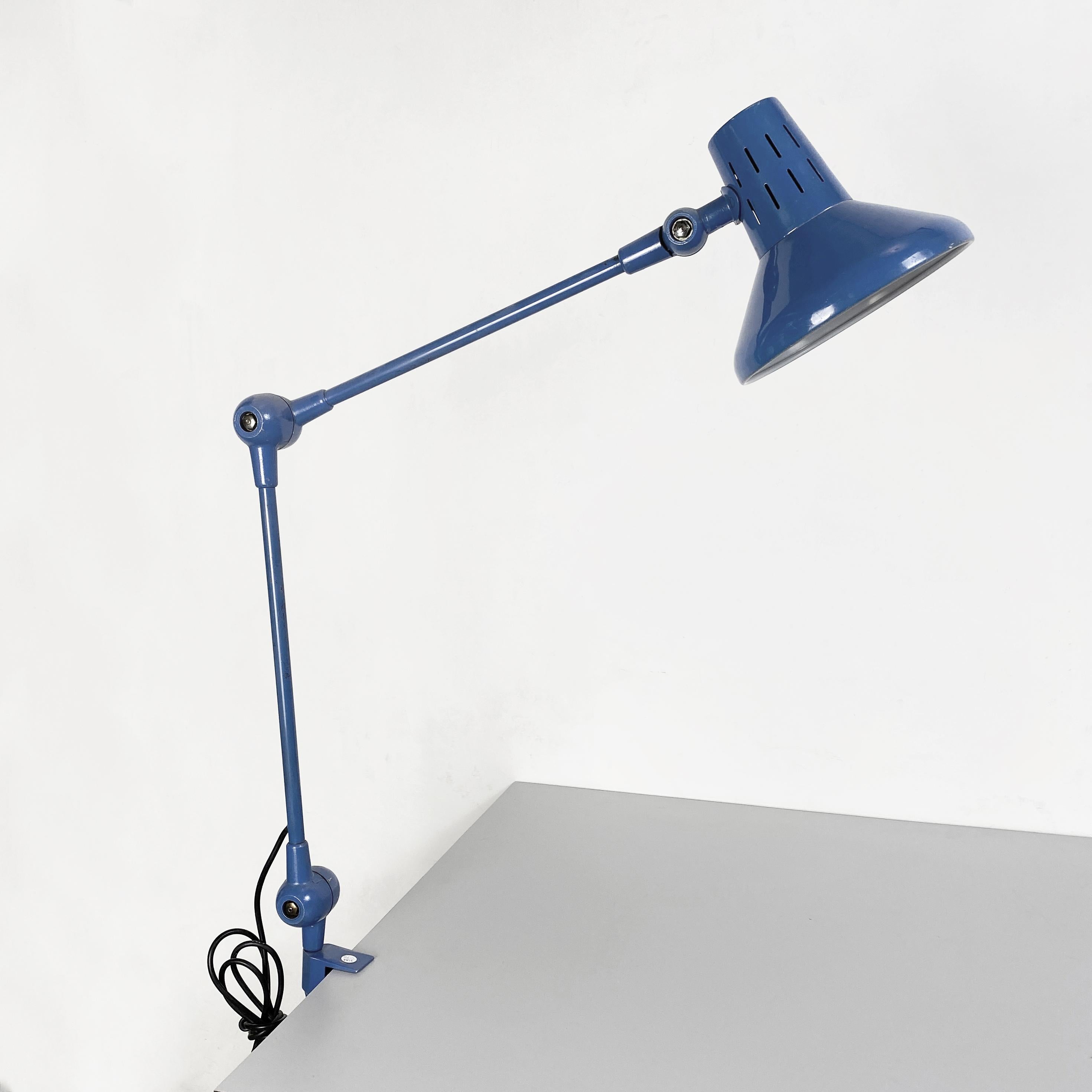 Italian Mid-Century Modern Blue metal table lamp with clamp, 1970s
Metal table lamp with clamp, in blue painted metal and white lampshade inside. Switch on the lampshade.

1970s.

Good conditions, with some signs.

Measure in cm 21x60x82h.