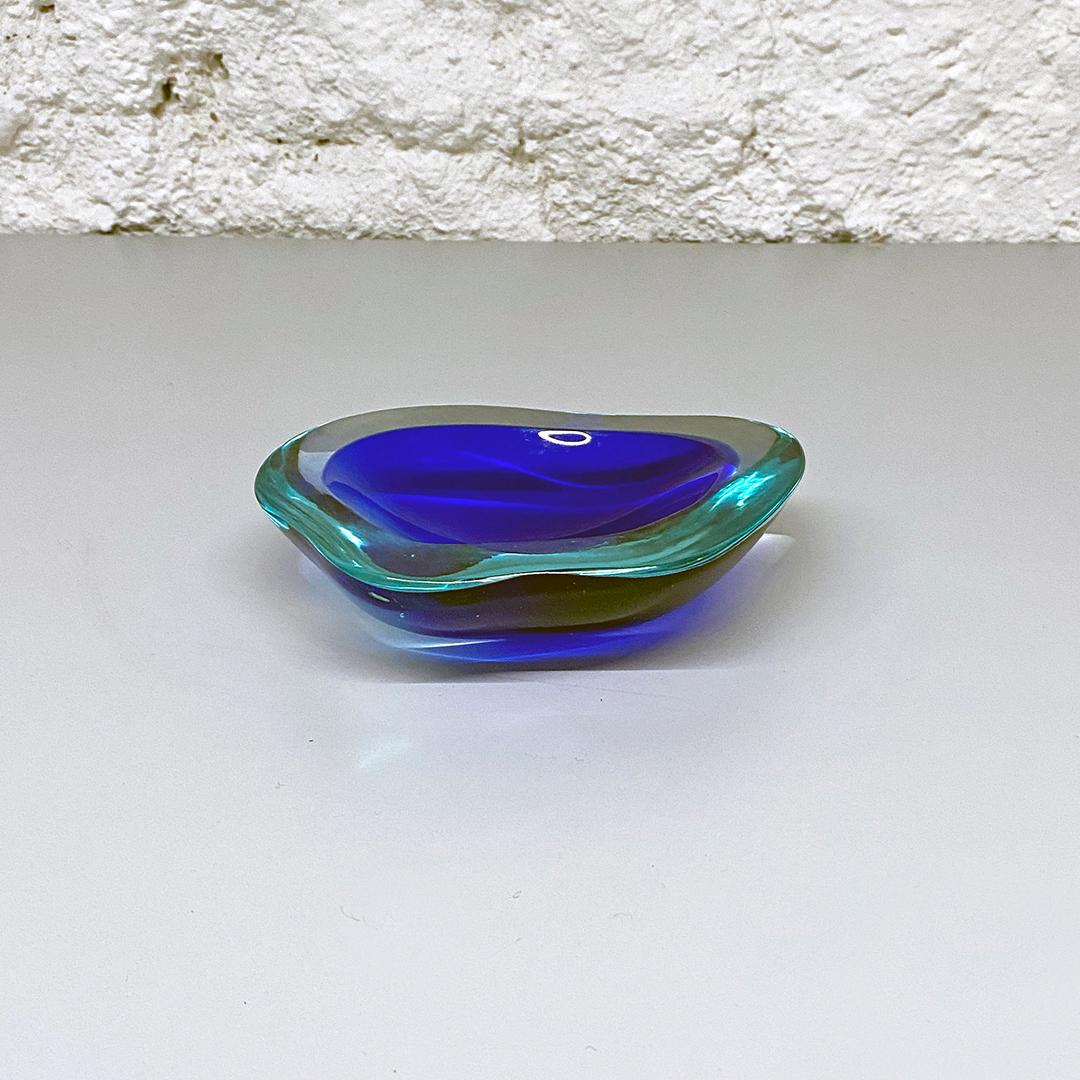 Italian Mid-Century Modern blue Murano glass ashtray with irregular shape, 1970s
Blue Murano glass ashtray with border and blue shades in irregular shape.

Excellent condition, some signs of aging.

Measurements: 15.5 x 12.5 x 3.5 H cm.