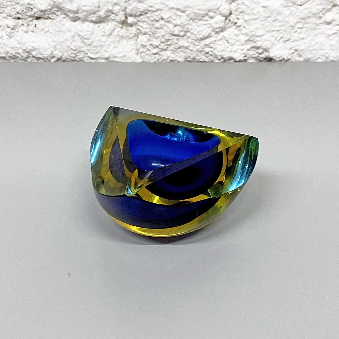 Italian Mid-Century Modern blue Murano glass ashtray with yellow shades, 1970s
Blue Murano glass ashtray with blue and yellow shades from the 1970s period

In very good conditions, without any imperfection

Measures 11 D x 6 H cm.

This Fantastic