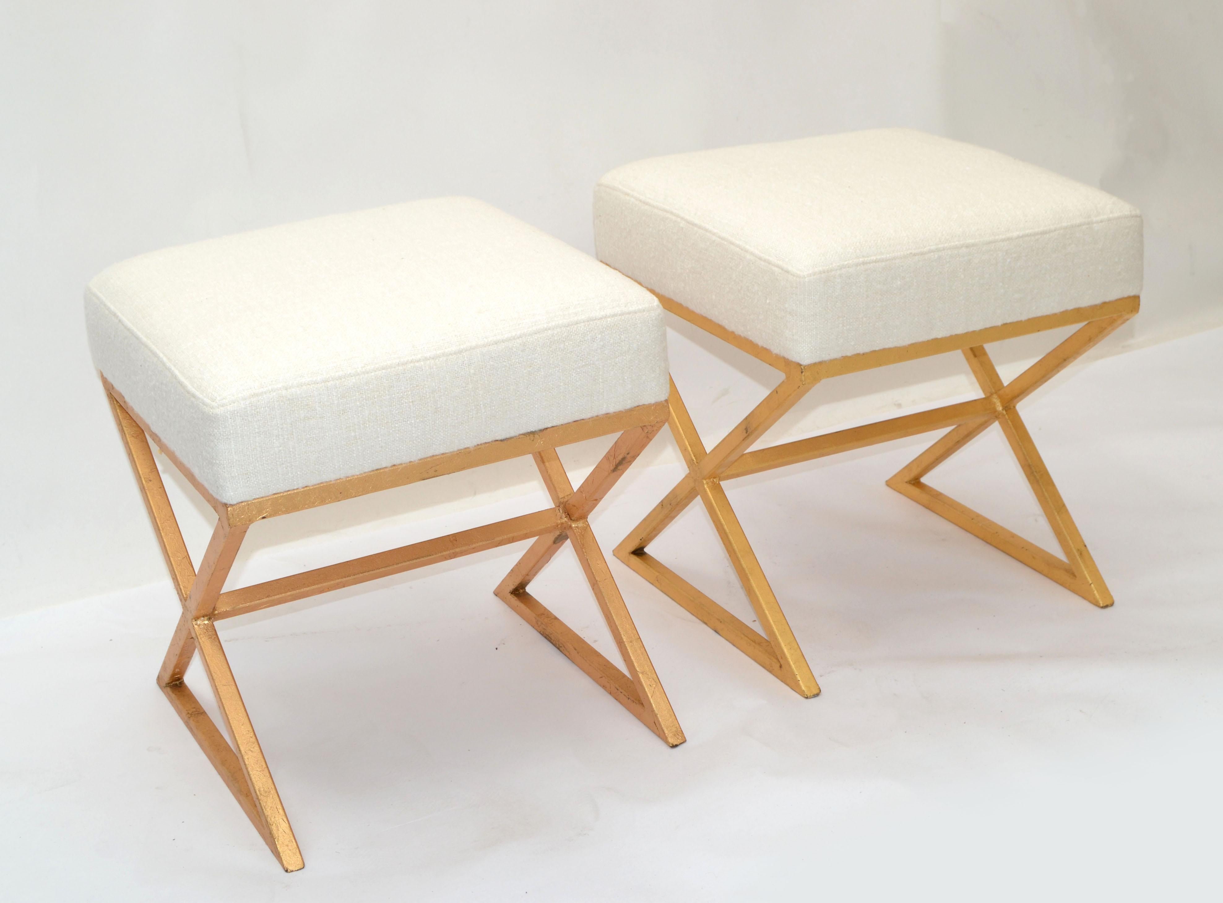Decorative pair of Italian stools in new cream Bouclé upholstery with a gilt painted X shaped steel base.
The Base has some wear due to age and History.


